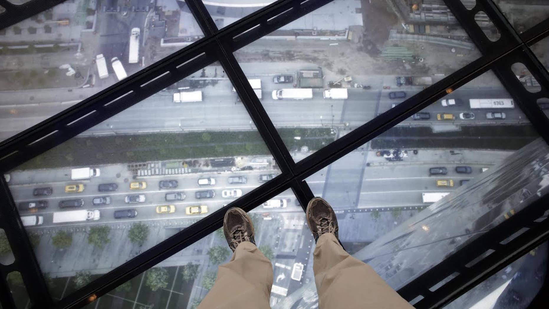 A view through the Sky Portal shows a live video view of the streets below from One World Observatory, Wednesday, May 20, 2015, in New York. The observatory atop the 104-story One World Trade Center opens to the public on May 29. (AP Photo/Mark Lennihan)