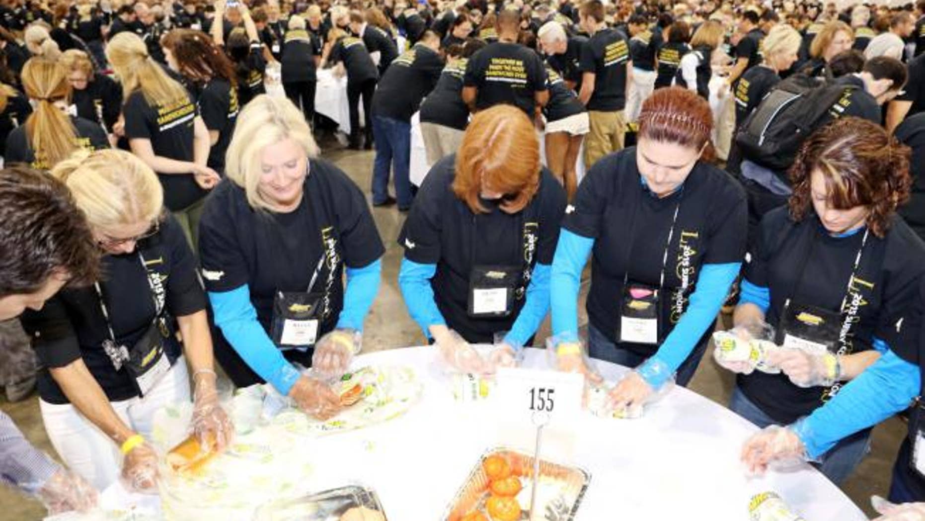 Subway employees from around the world gathered to break the current record for simultaneous sandwich making.