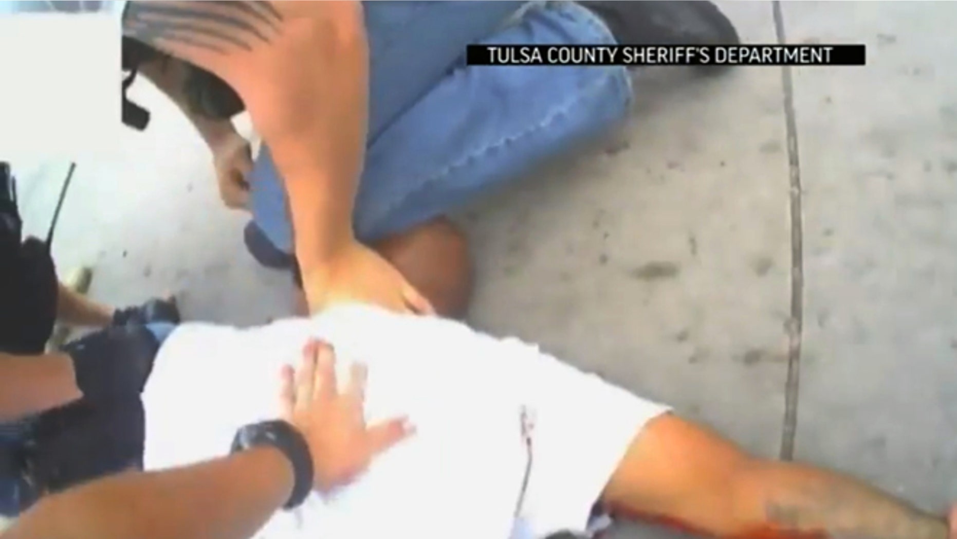 April 2, 2015: In this screen shot from a video provided by the Tulsa County Sheriff's Office, police restrain 44-year-old Eric Harris after he was chased down and tackled by a Tulsa County Deputy, and then shot by a reserve sheriff's deputy while in custody, in Tulsa, Okla.