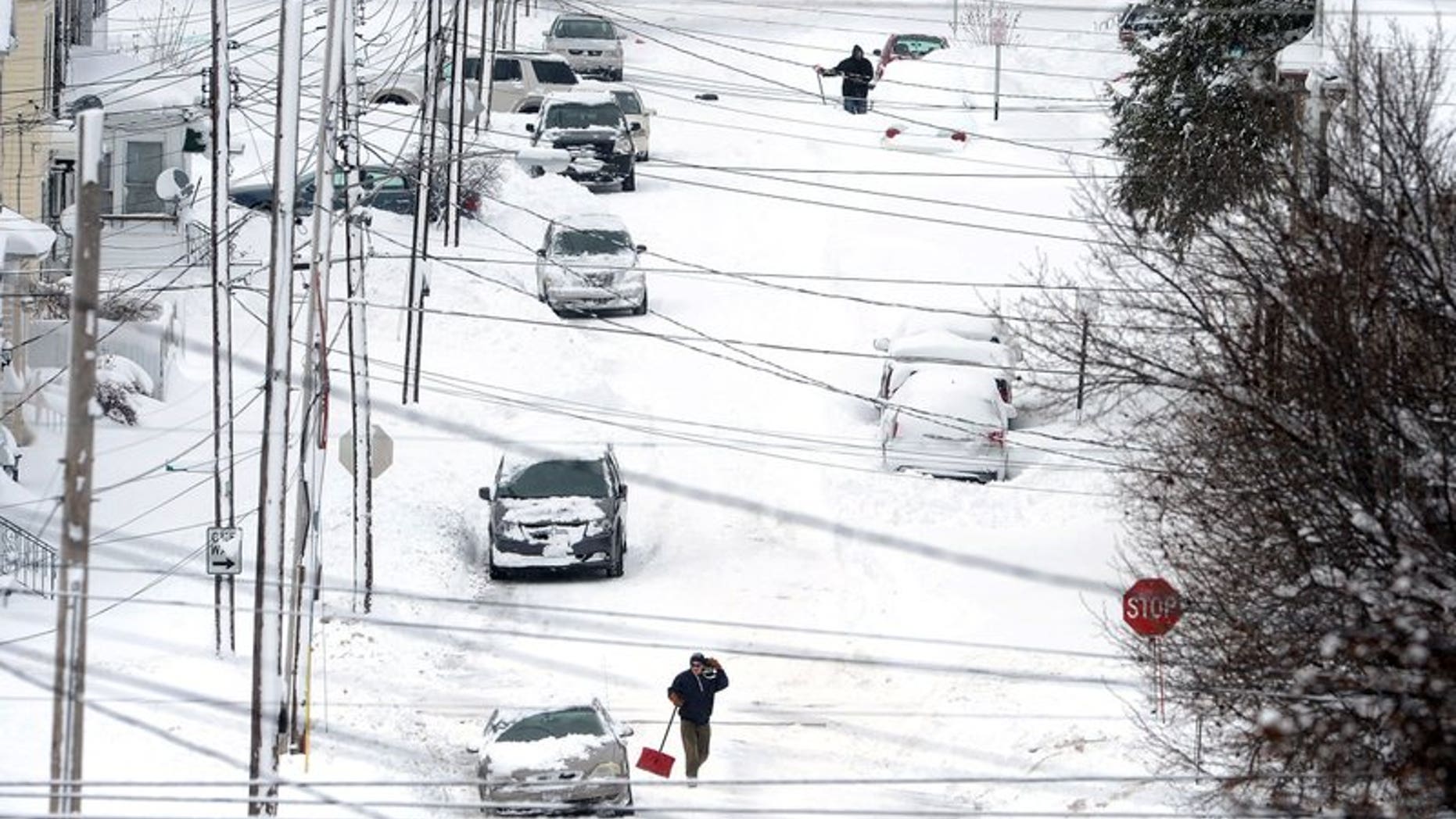 Erie, Pa., residents dig out on Tuesday, Dec. 26, 2017, after an unprecedented two-day snowfall. The National Weather Service office in Cleveland says the storm brough 34 inches on Christmas Day, a new all-time daily snowfall record for Erie.