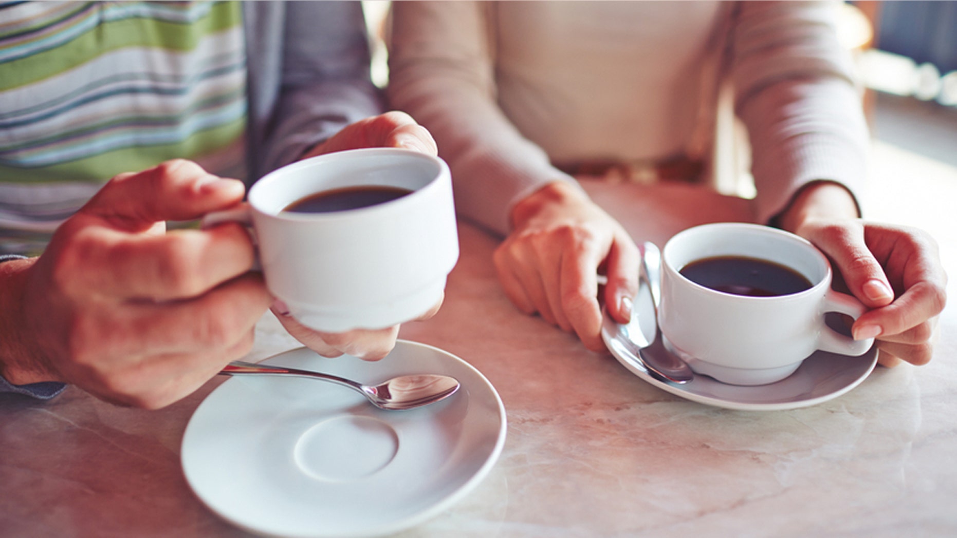 Close-up of couple drinking coffee