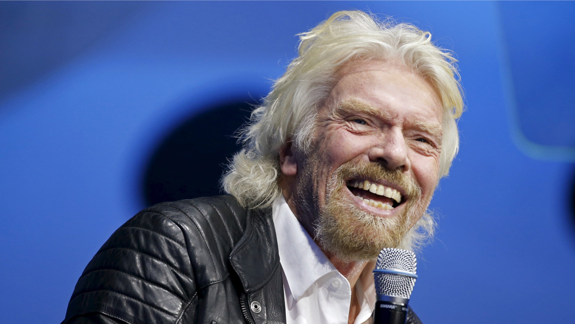 Richard Branson unveils the new SpaceShipTwo, a six-passenger two-pilot vehicle meant to ferry people into space that replaces a rocket destroyed during a test flight in October 2014, in Mojave, California, United States, February 19, 2016. REUTERS/Lucy Nicholson - RTX27RNX