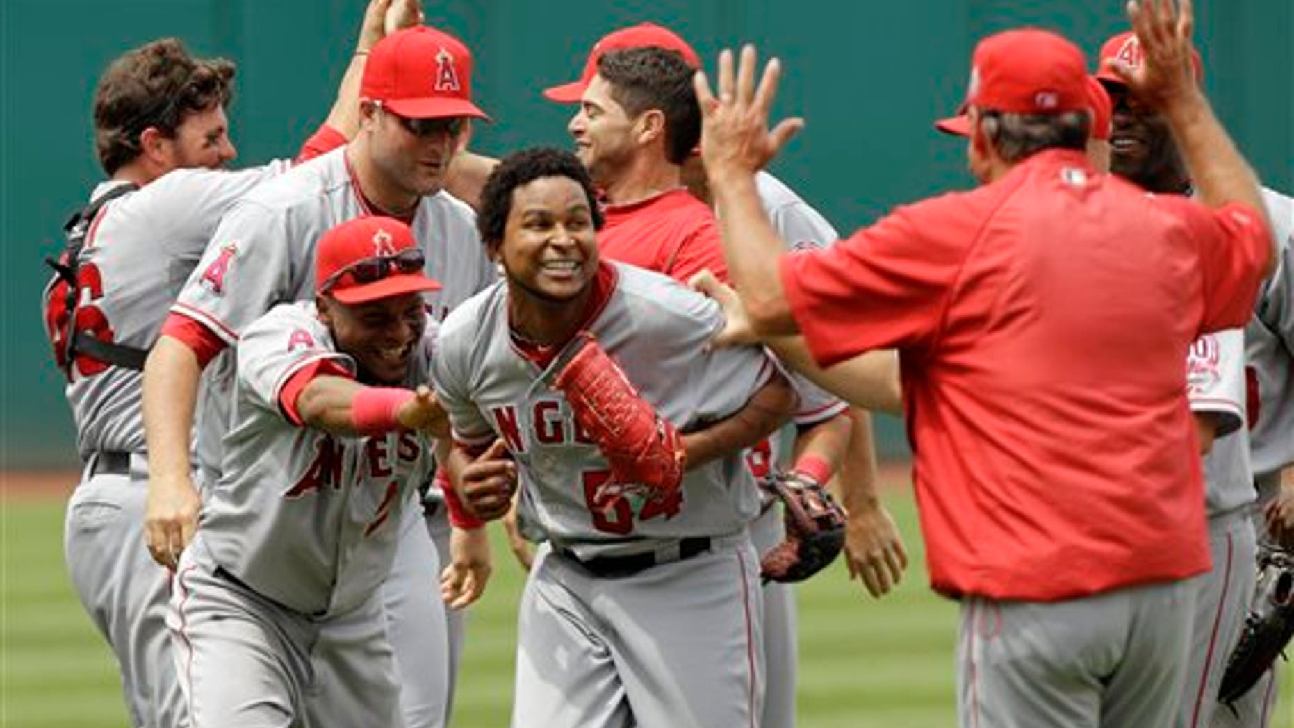 Los Angeles Angels starting pitcher Ervin Santana, center, celebrates with his teammates after pitching a no-hitter against the Cleveland Indians in a 3-1 win of a baseball game Wednesday, July 27, 2011, in Cleveland. (AP Photo/Mark Duncan)