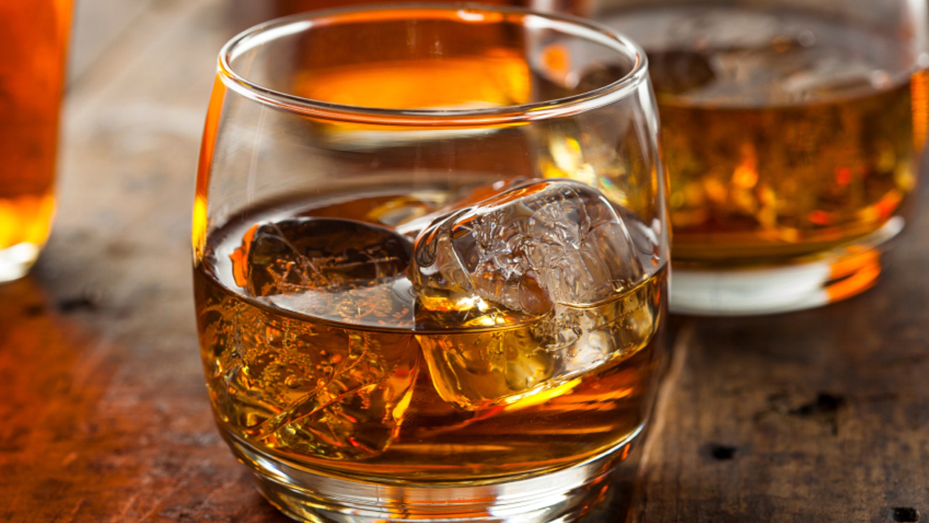 Alcoholic Amber Whiskey Bourbon in a Glass with Ice