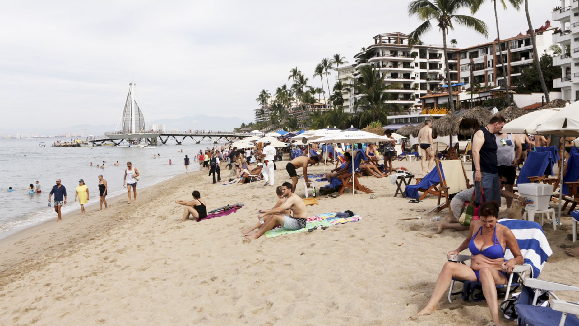 Tourists are seen along the beach resort of Puerto Vallarta, Mexico, December 31, 2015. REUTERS/Henry Romero - RTX20OU9