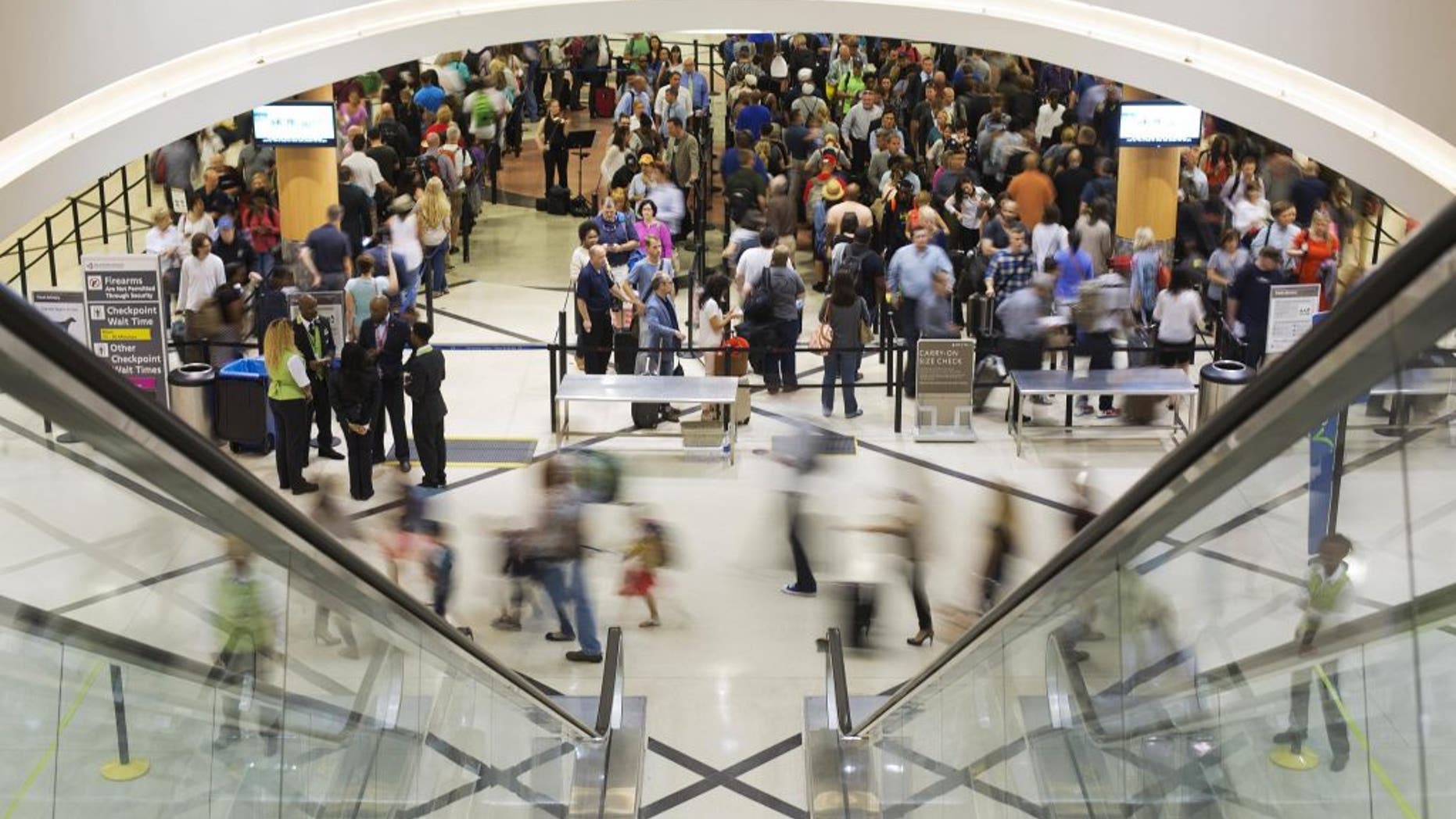 Airline travelers move through a TSA line at Atlanta's Hartsfield-Jackson International Airport.