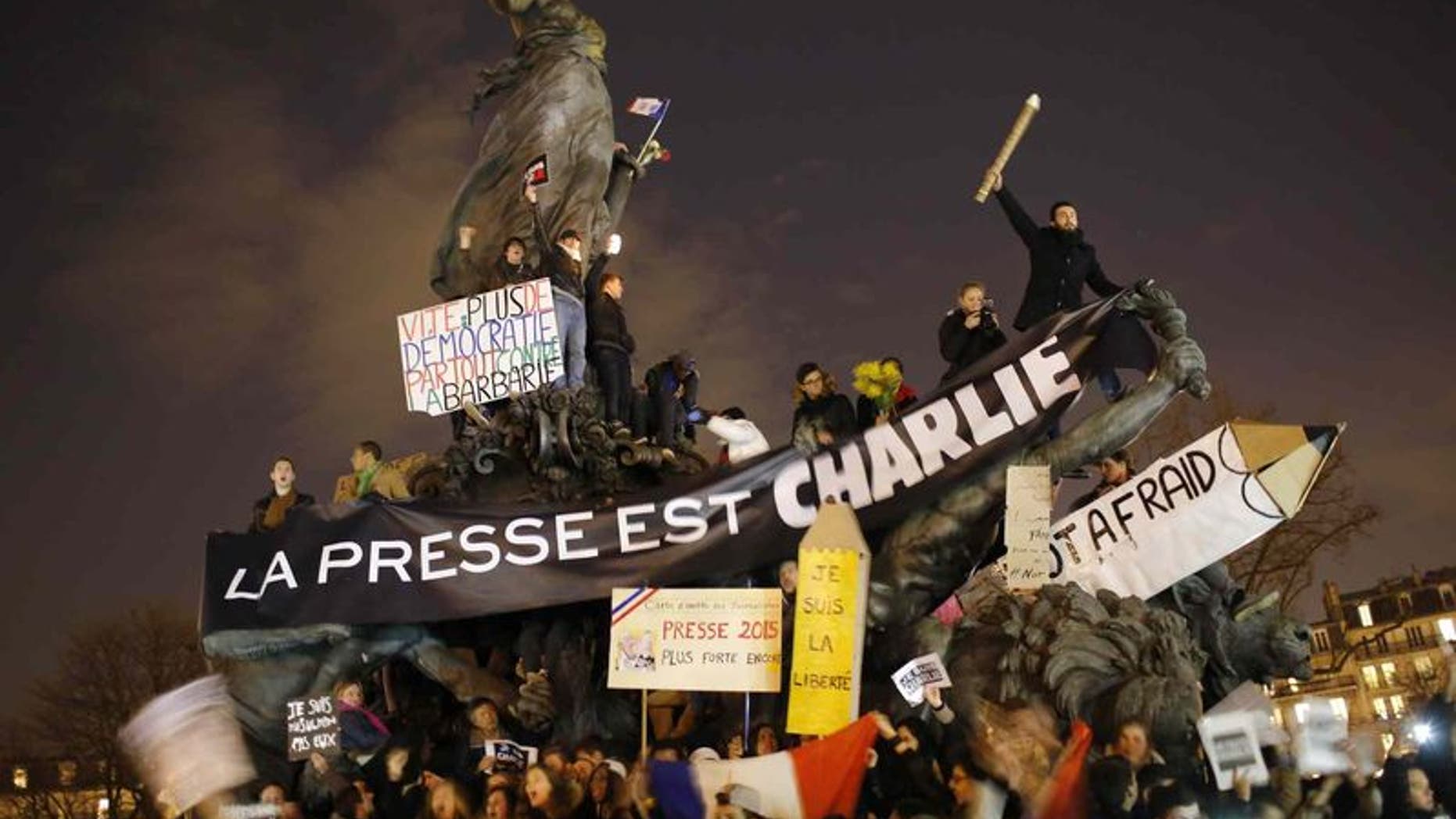 Hundreds of thousands of people marched through Paris on Sunday in a massive show of unity and defiance in the face of terrorism that killed 17 people in France's bleakest moment in half a century