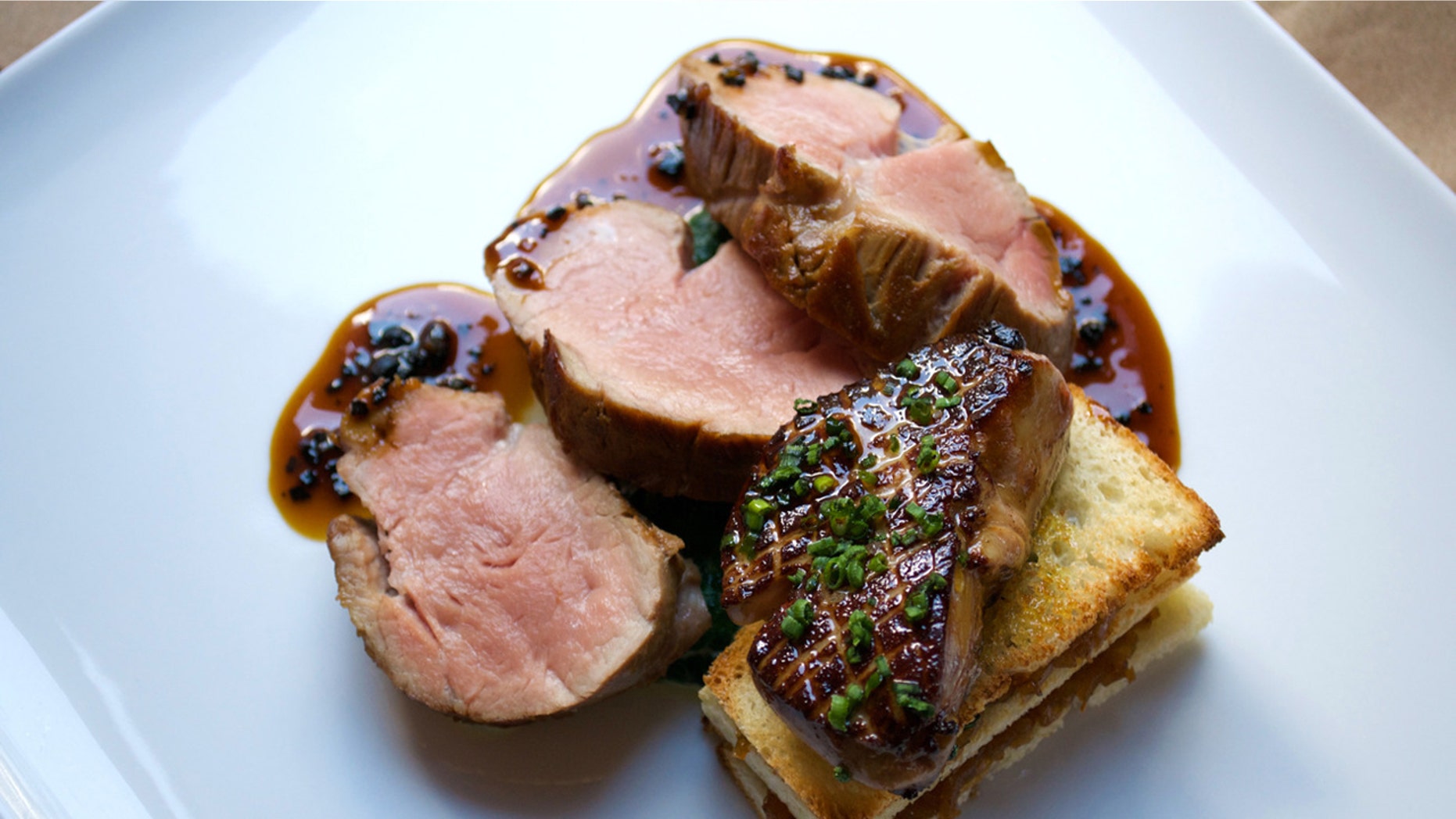 The veal tenderloin served with foie gras, a caramelized onion tartine, and black truffle jus at Altamarea's Vaucluse.