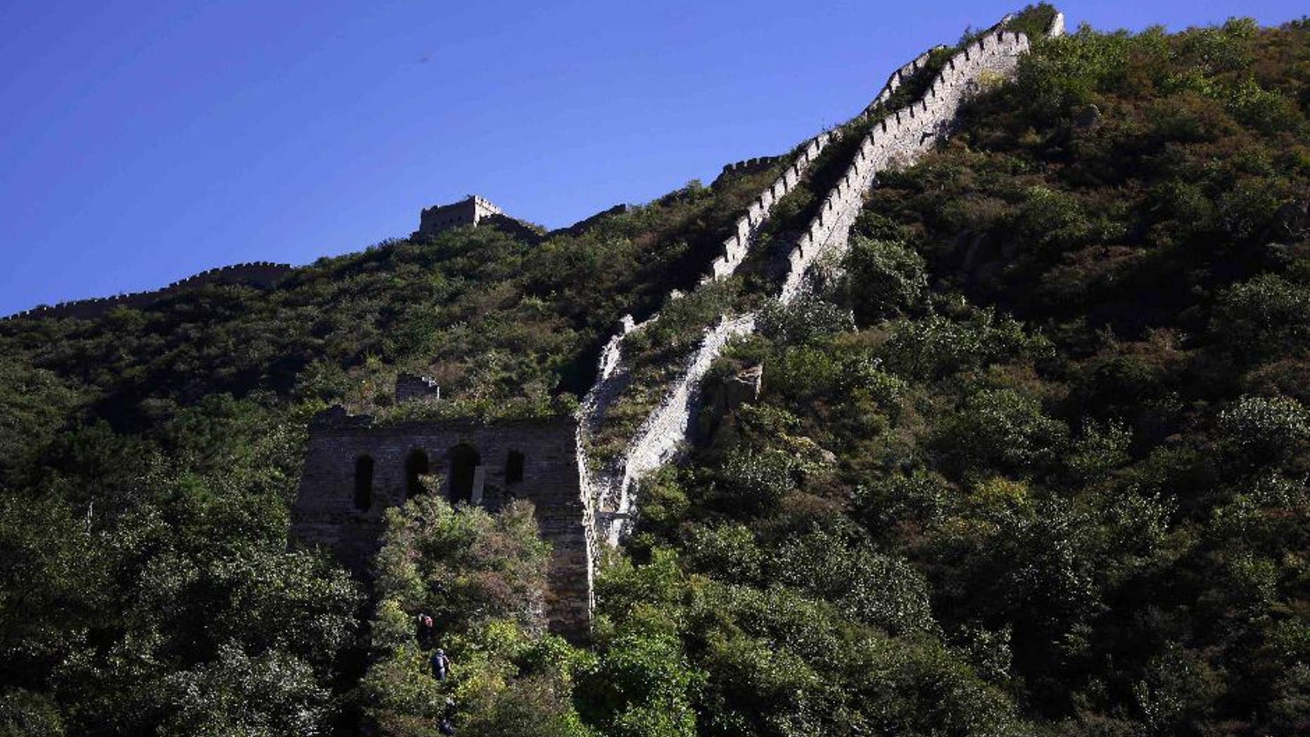 Chinese hikers make their way up an overgrown, hidden section of the Great Wall of China located near Xiang Shui Hu village.