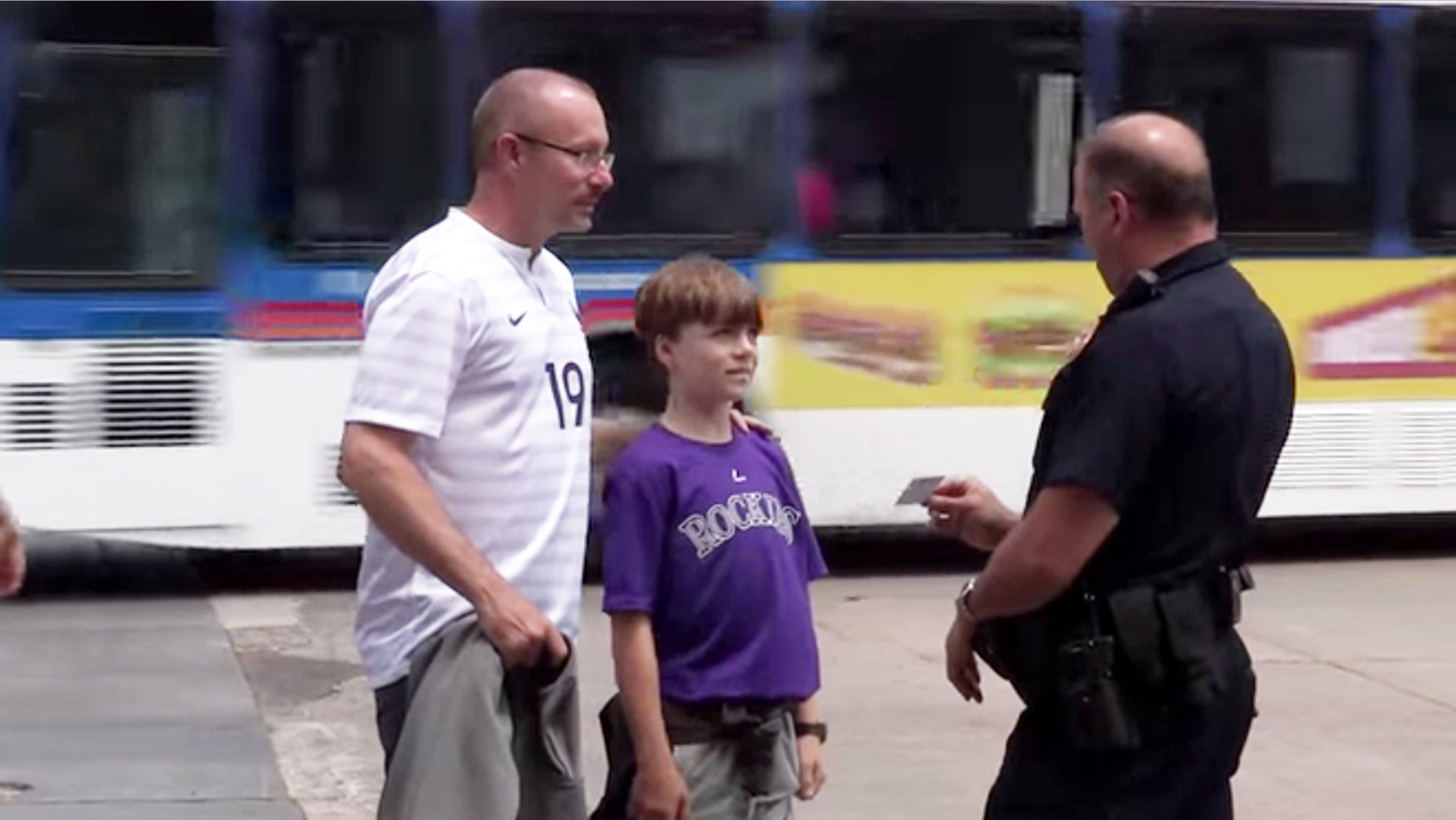 A police officer hands out a pizza card to well behaved duo.