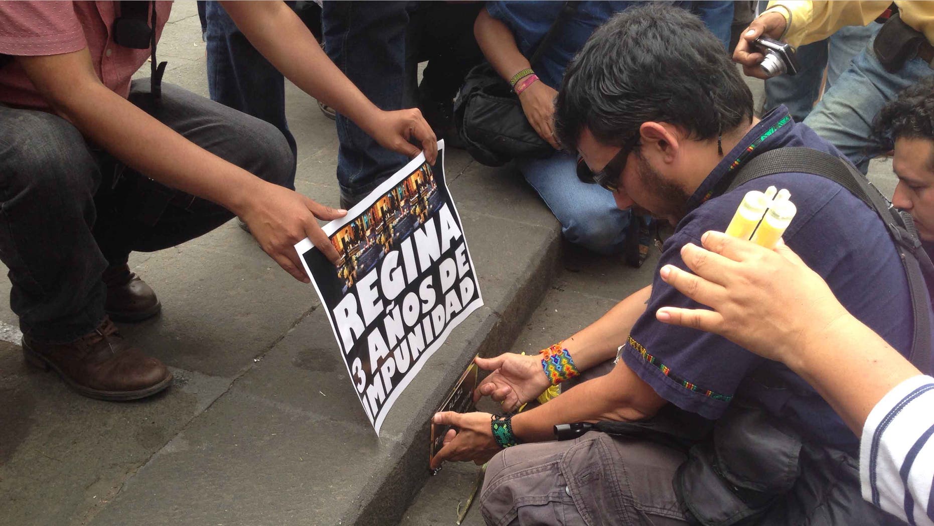 Ruben Espinosa on April 28, 2015, placing a plaque to rename a plaza after slain journalist Regina Martinez.