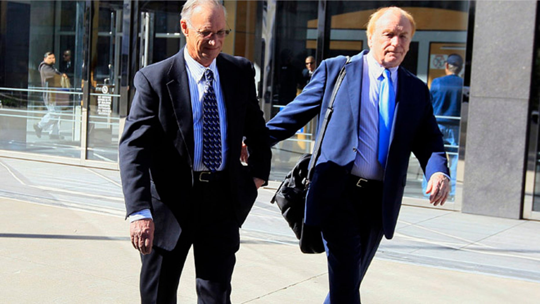 March 8, 2012: Robert Maegerle, left, walks out of a federal courthouse with attorney Jerome Froelich Jr. in San Francisco.