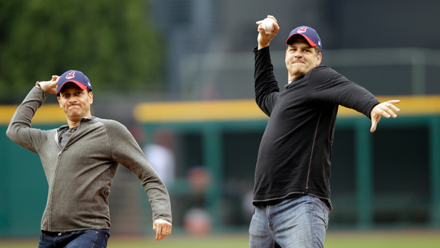 In this May 8, 2012, file photo, ESPN radio hosts Mike Greenberg, left, and Mike Golic throw out first pitches before a baseball game between the Cleveland Indians and the Chicago White Sox in Cleveland. The network announced Tuesday, May 16, 2017, that Greenberg would be leaving the longtime morning radio show he co-hosts with Golic to host a new morning TV show on ESPN TV that will premier Jan. 1.
