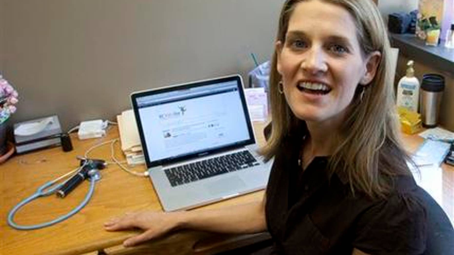 In this Friday, June 8, 2012 photo, Dr. Natasha Burgert talks about using social media in her practice at her office in Kansas City, Mo. There's a stereotype that says doctors shun technology that might threaten patients' privacy and their own pocketbooks. But a new breed of physicians is texting health messages to patients, tracking disease trends on Twitter, identifying medical problems on Facebook pages and communicating with patients through email. (AP Photo/Orlin Wagner)