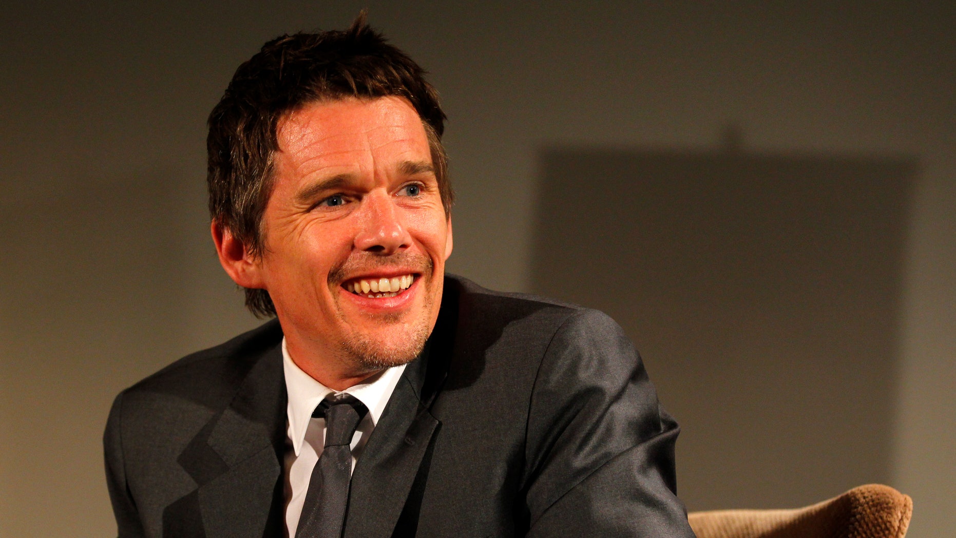 June 26, 2013. Ethan Hawke smiles during a news conference in Bucharest.