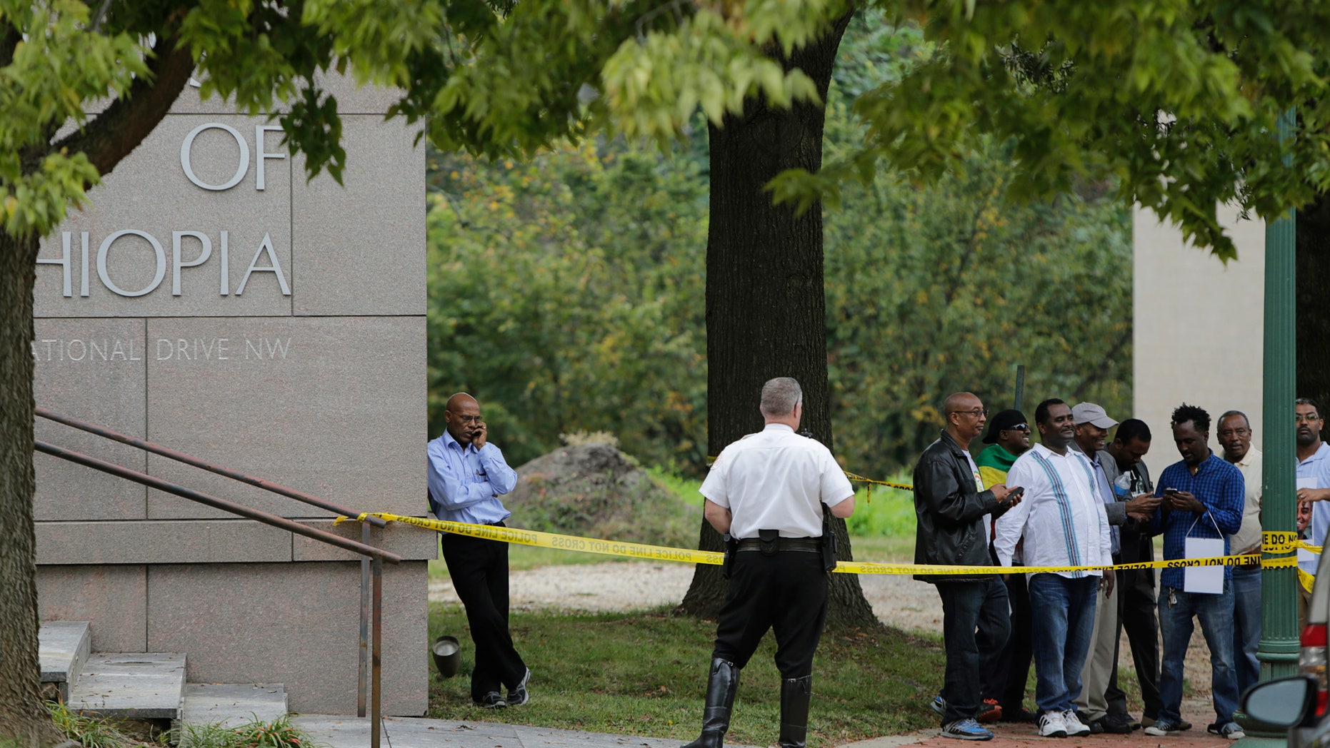 Sept. 29, 2014: A United States Secret Service policeman stands at the back of a police line tape near protestors at the Ethiopian Embassy in Washington.
