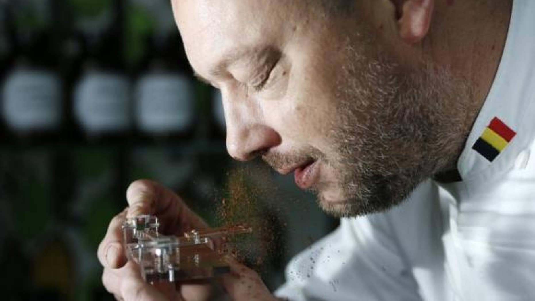 Belgian chocolatier Dominique Persoone snorts cocoa powder off his Chocolate Shooter device. Reuters