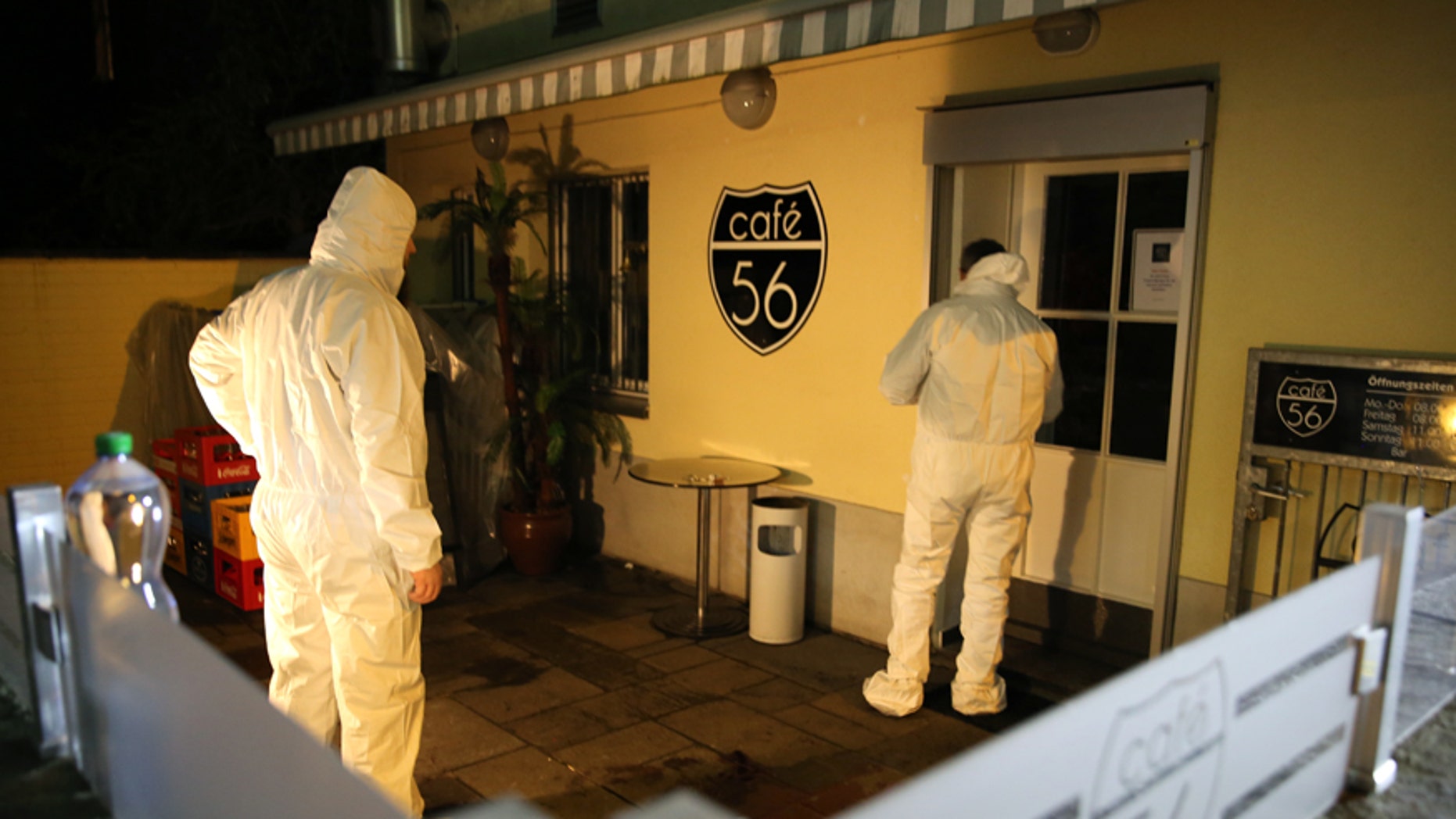 A forensic team investigates the scene after deadly gunfire was unleashed in Cafe 56, Friday, March 10, 2017, in Basel, Switzerland. (AP Photo/Dominique Soguel)