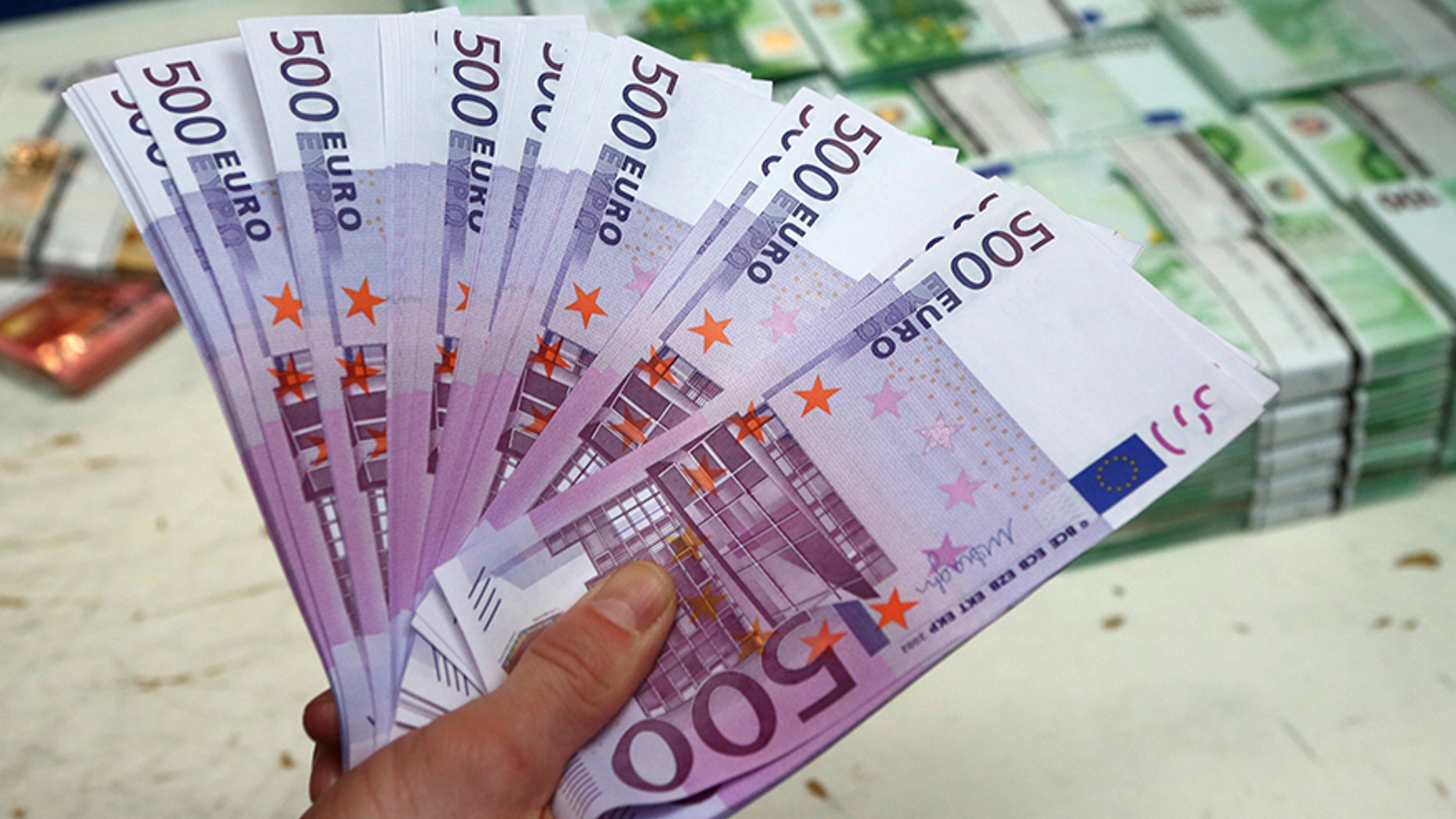 March 3, 2016: An employee holds 500 euro banknotes in the Money Service Austria company's headquarters in Vienna, Austria.