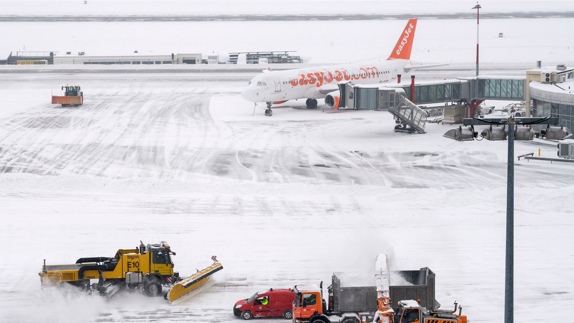 The fire brigade of Airport Security Services (SSA) rides snowplows removing snow on the runway during at the Geneva Airport, in Geneva, Switzerland, Thursday, March 1, 2018.