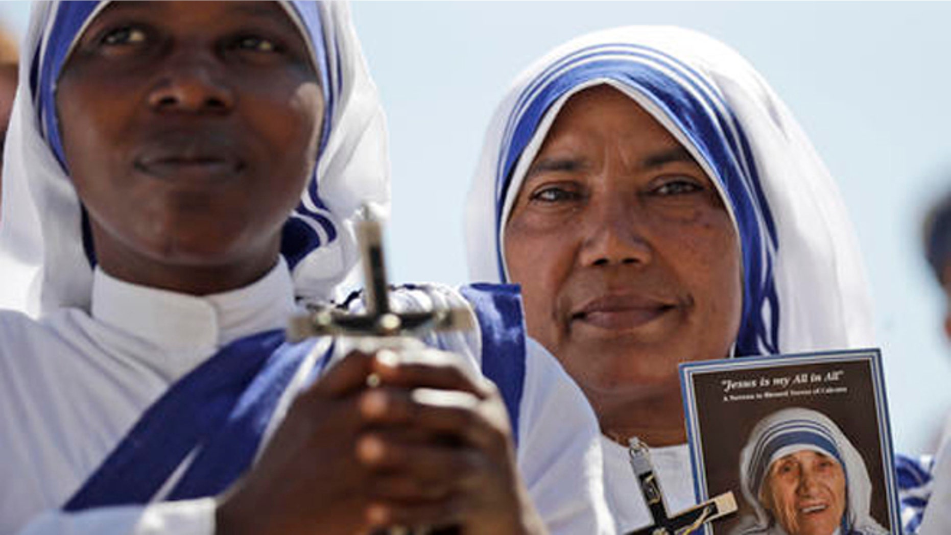 Missionaries of Charity nuns holds a photo of Mother Teresa in St. Peter's Square at the Vatican during a jubilee audience for workers and volunteers of mercy led by Pope Francis, Saturday, Sept. 3, 2016. The square hosts a ceremony Sunday expected to draw hundreds of thousands of admirers of Mother Teresa, a nun who before her death in 1997, cared for the destitute who were dying in the streets of India. (AP Photo/Alessandra Tarantino)