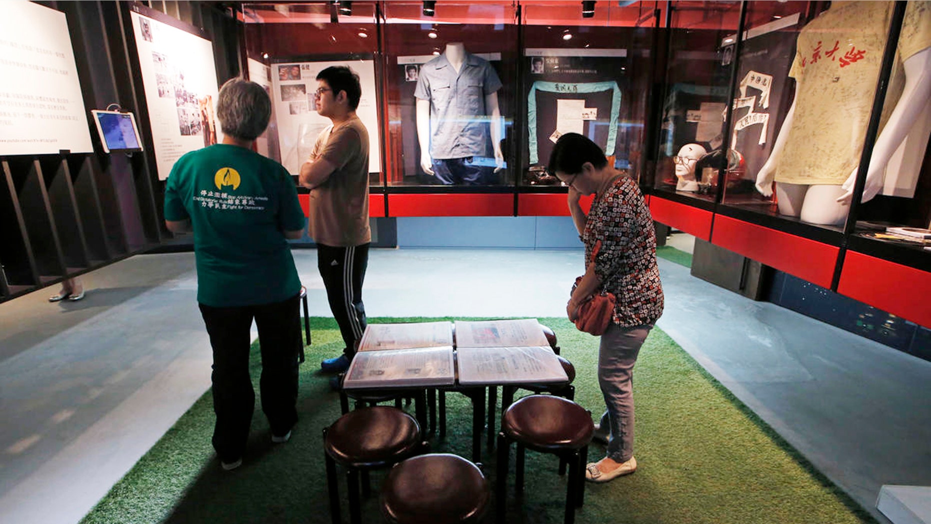 Visitors look at the exhibits in the June 4th Museum in Hong Kong, Friday, April 15, 2016. The operators of the worlds only museum chronicling the Chinese governments brutal 1989 crackdown on student protesters in Beijings Tiananmen Square say it faces closure because of a legal dispute. (AP Photo/Kin Cheung)