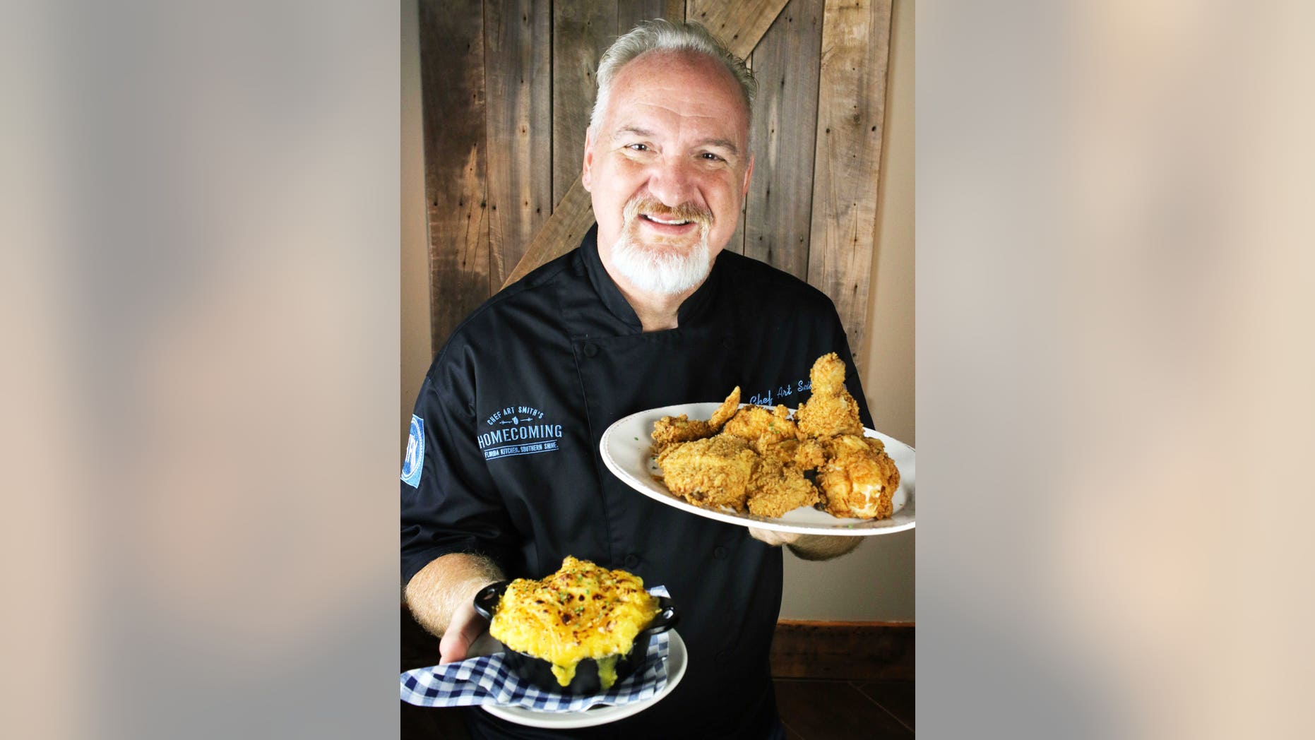 Chef Art Smith shows off the fried chicken and macaroni and cheese dishes planned for his new Orlando restaurant, Homecoming: Florida Kitchen and Southern Shine at Disney Springs.