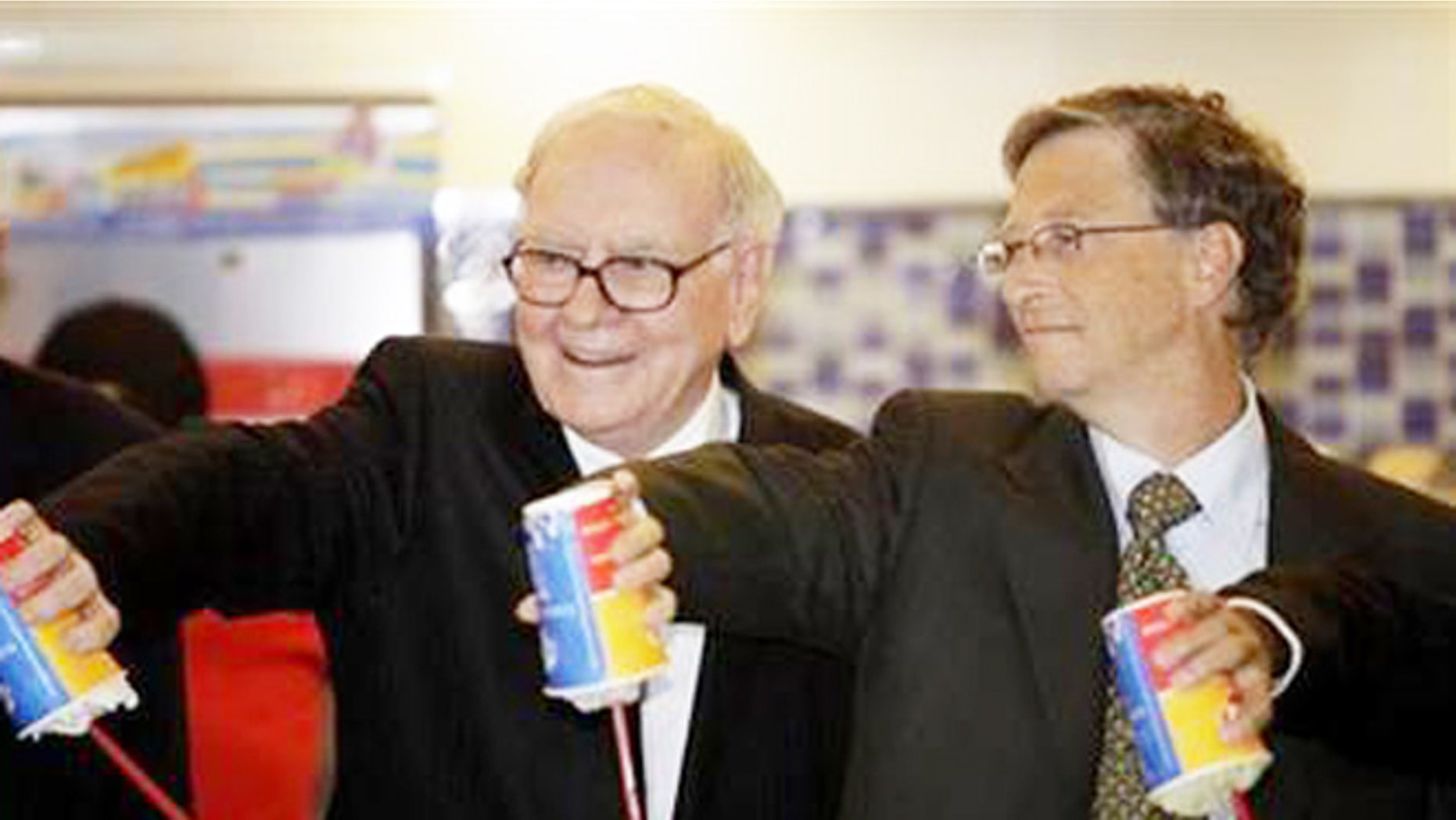 Warren Buffet (L) and Bill Gates test out Dairy Queen Blizzards.