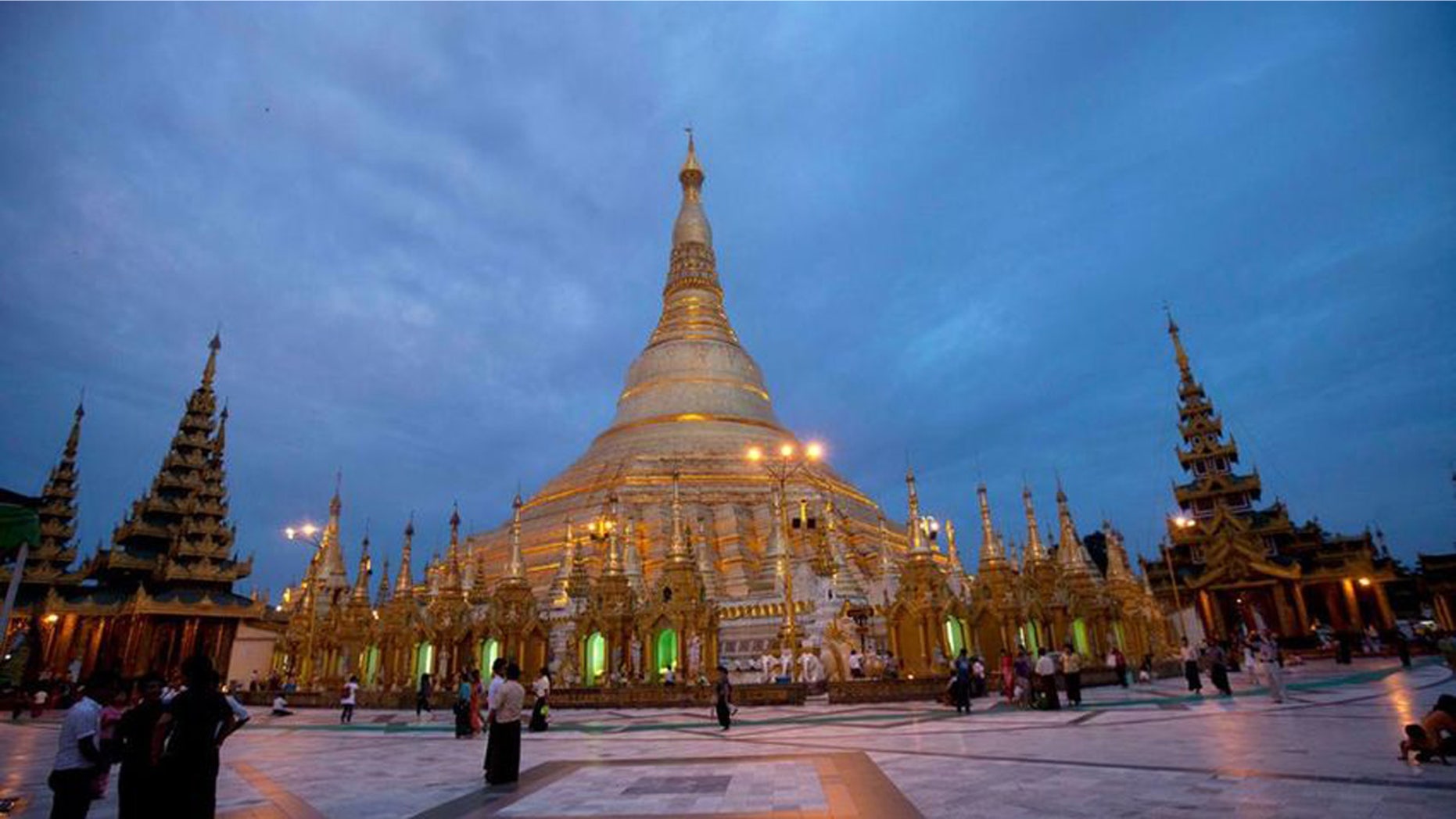 Buddhist devotees visit Myanmar's famous Shwedagon Pagoda as its illuminated in Yangon, Myanmar on Aug. 13, 2014.