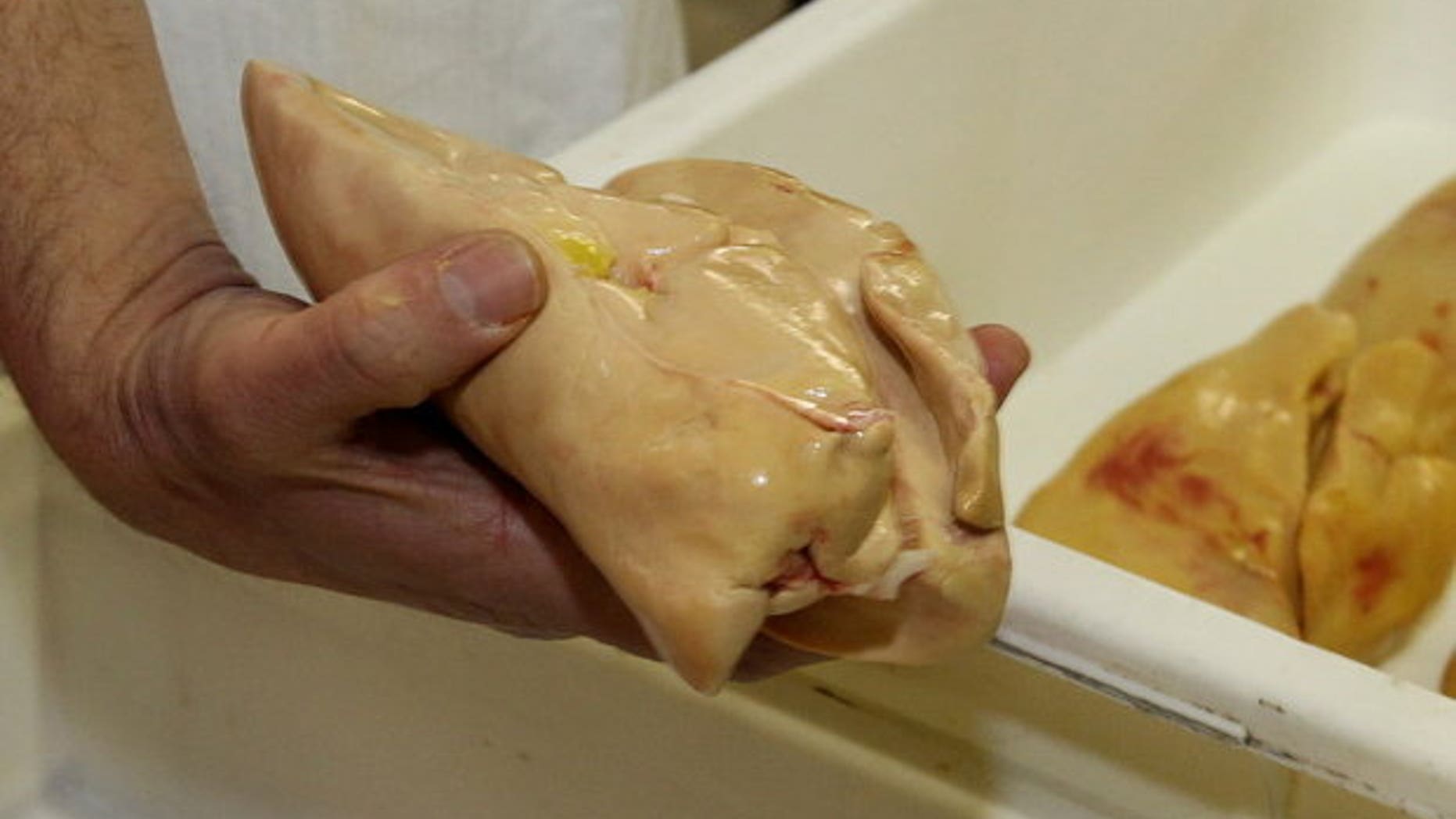 A chef displays a lobe of foie gras. Farmers in southwestern France have been banned from producing the delicacy for three months over concerns of avian flu.