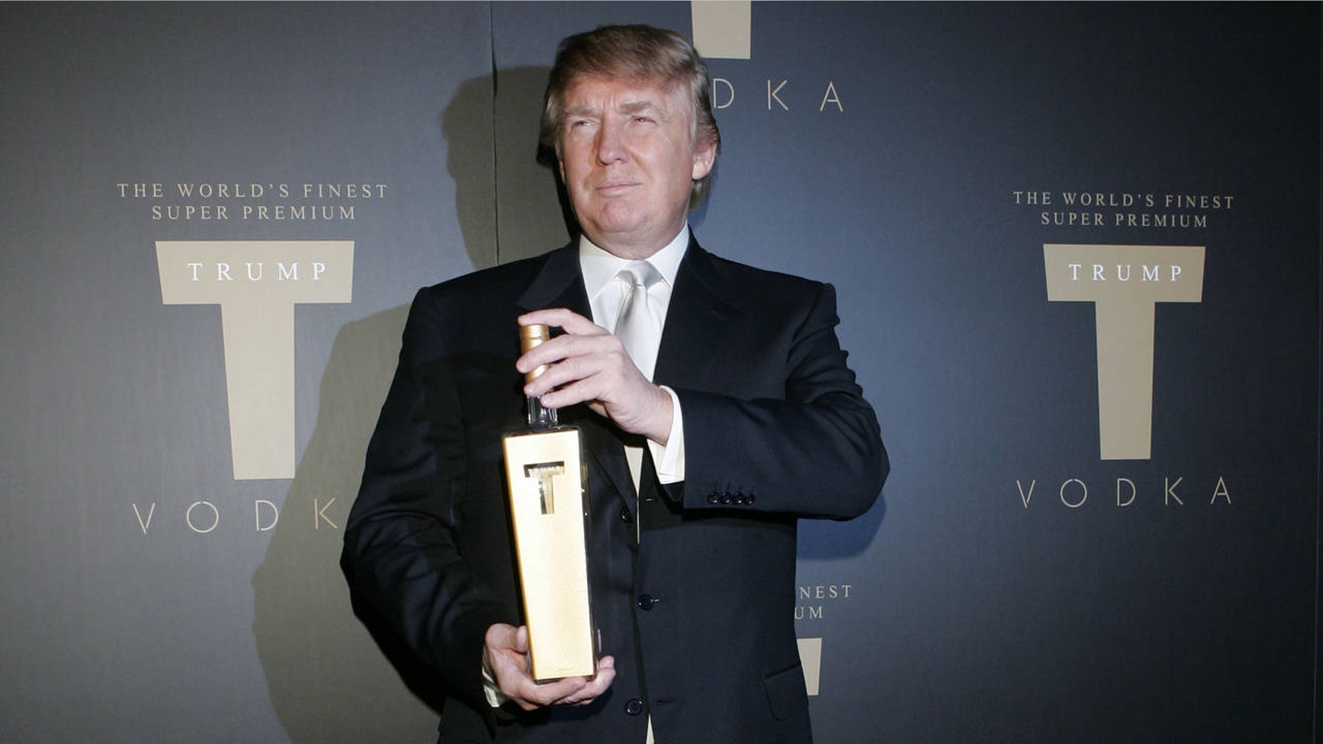 Donald Trump poses with a bottle of liquor from his now defunct vodka line.