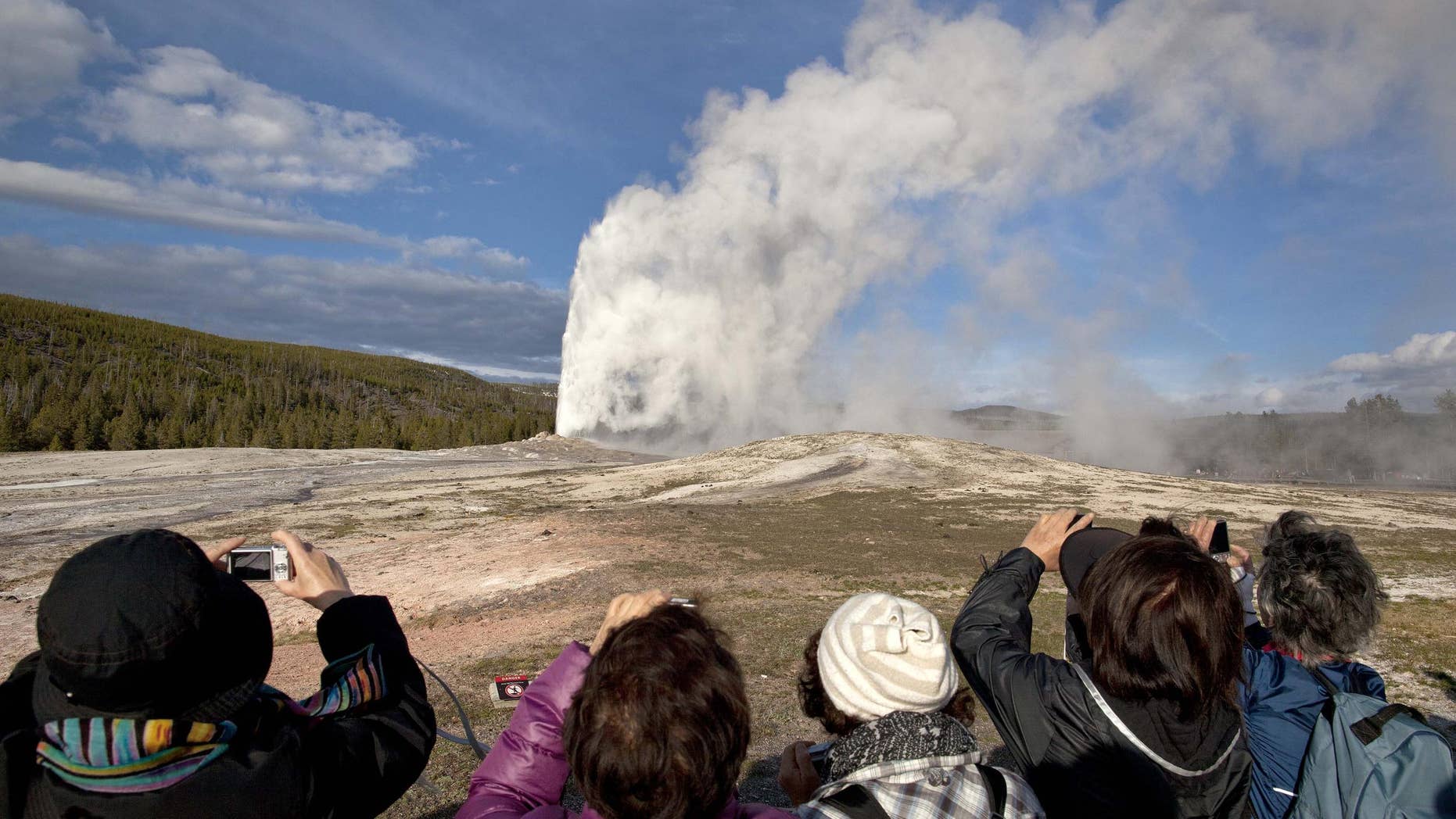 Tourists really enjoying Yellowstone. Get out of the car to make the most of your next national park visit.