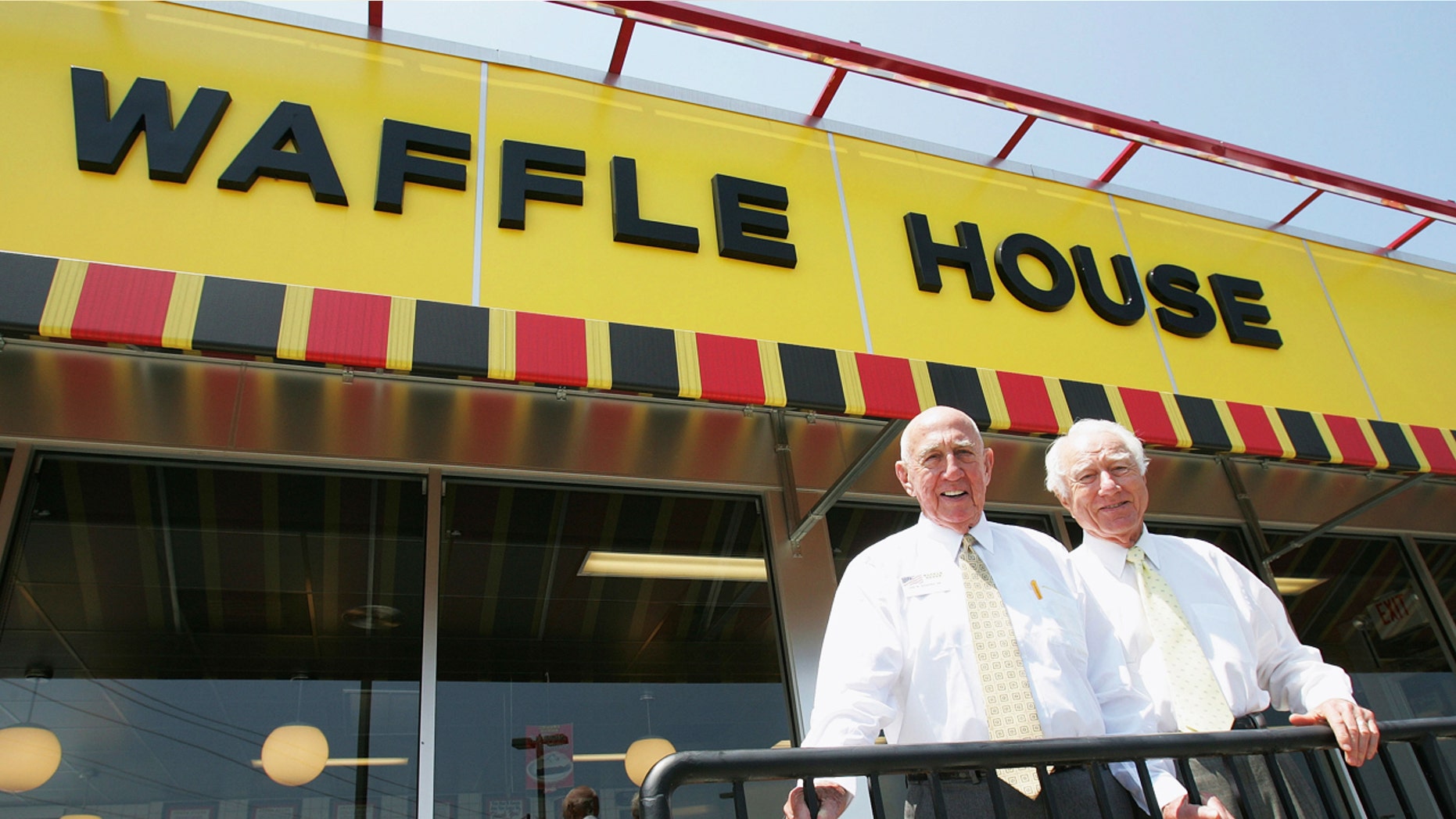 FILE - In this file photo taken July 26, 2005, Waffle House founders Joe Rogers Sr., left, and Thomas Francis Forkner Sr. pose in front of a Waffle House restaurant after eating lunch at the establishment in Norcross, Ga. Forkner, who jumped from real estate to the restaurant business when he co-founded Waffle House in the 1950s, has died weeks after the death of his business partner who helped him create the famous Southern diner chain. Waffle House said in a statement that Forkner died Wednesday, April 26, 2017, at age 98. (AP Photo/Ric Feld, File)