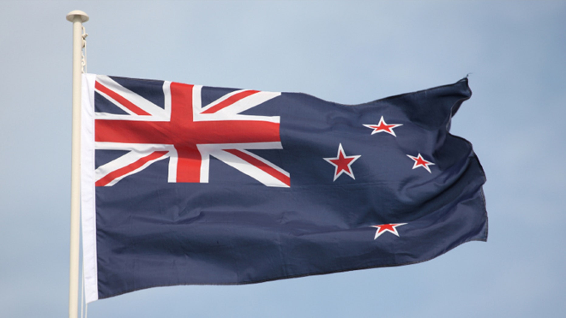 The New Zealand flag flying in strong wind. Some motion on flag edges.