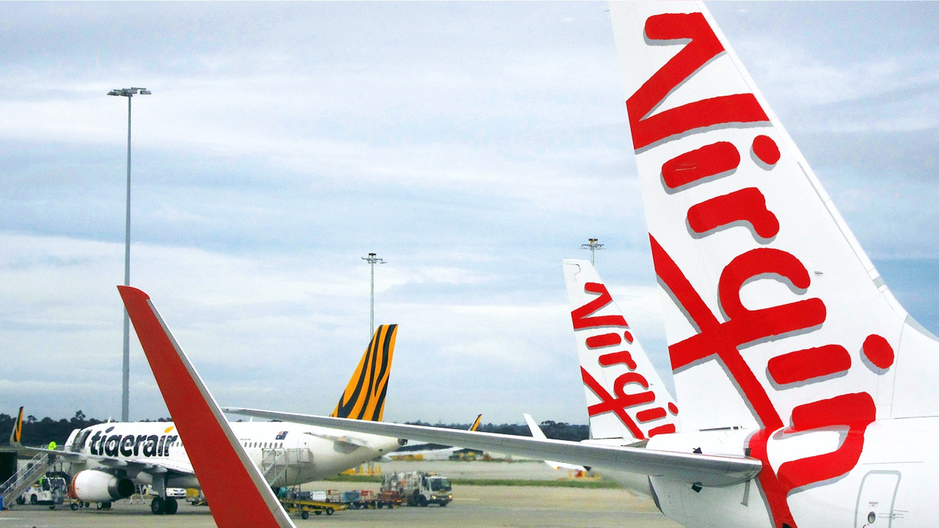A Tigerair Australia plane sits on the tarmac near Virgin Australia aircraft at Melbourne's Tullamarine International Airport, Australia, October 12, 2016. Picture taken October 12, 2016. REUTERS/David Gray - RTX2ZF7U