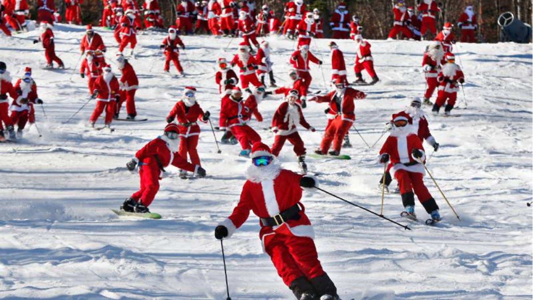 Skiers and snowboarders dressed as Santa take a run en masse at the Sunday River ski resort, Sunday, Dec. 6, 2015, in Newry, Maine. The annual Santa Sunday fundraising event raised $3,014 for the Sunday River Community Fund