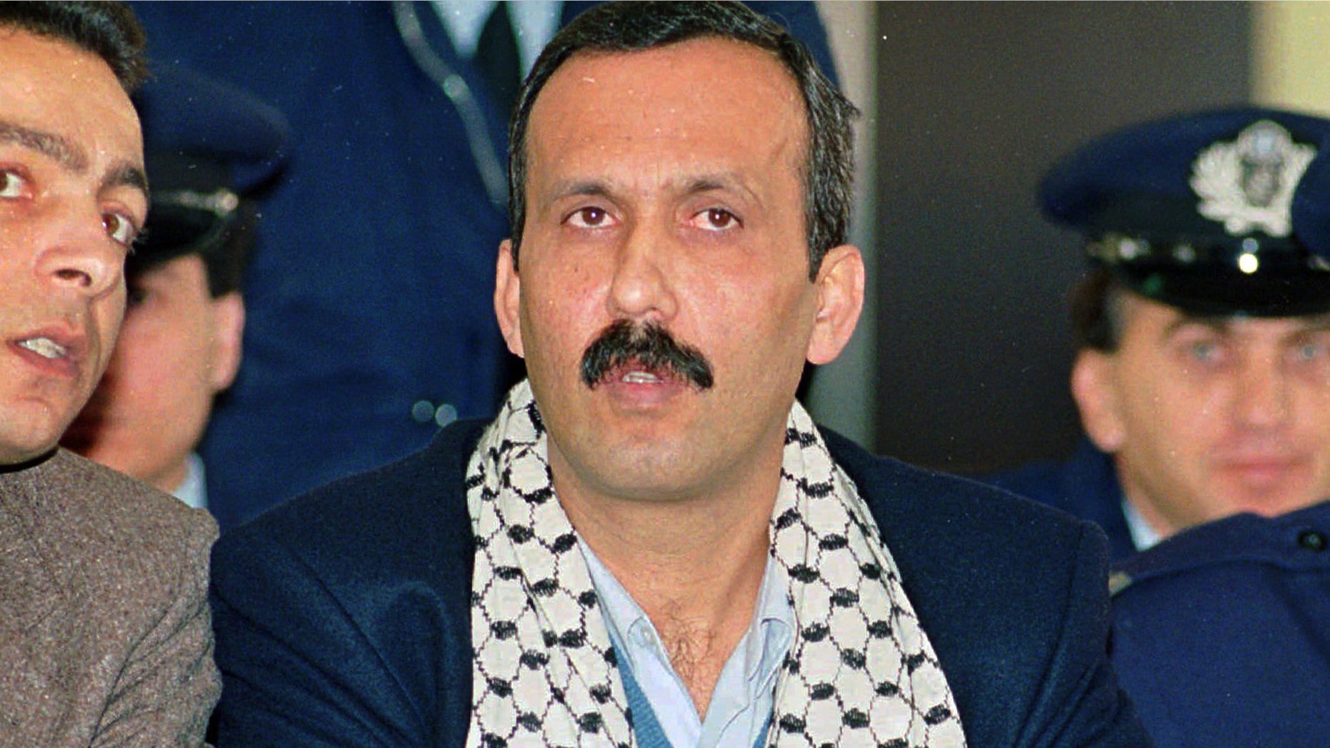 Dec. 12, 1991: Mohammed Rashed, center, convicted of the 1982 PanAm jetliner bombing, listens to his interpreter, left, during his appeals court hearing in Athens, Greece. When Rashed pleaded guilty in connection with the deadly 1982 explosion