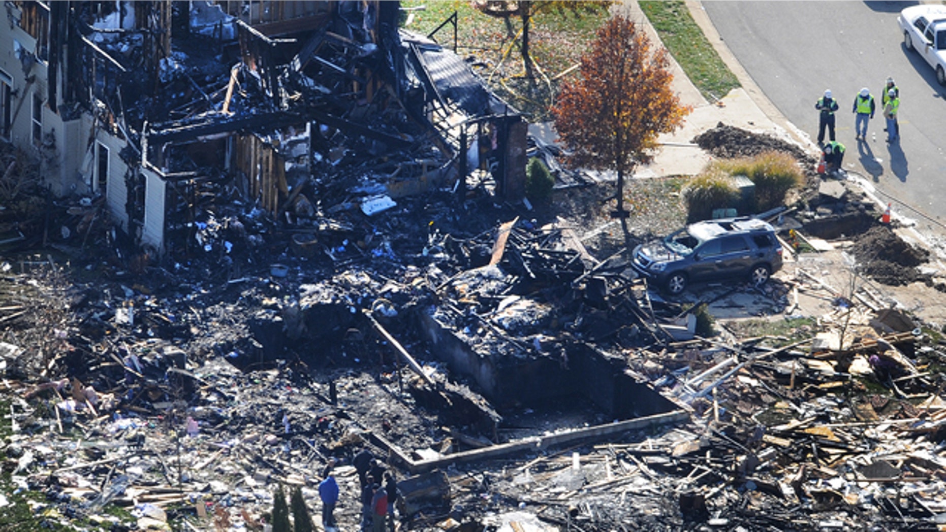Nov. 12, 2012: Citizens Energy workers continue their investigation Monday afternoon by digging into the front sidewalk looking for possible explanation into the explosion of a house in Indianapolis.