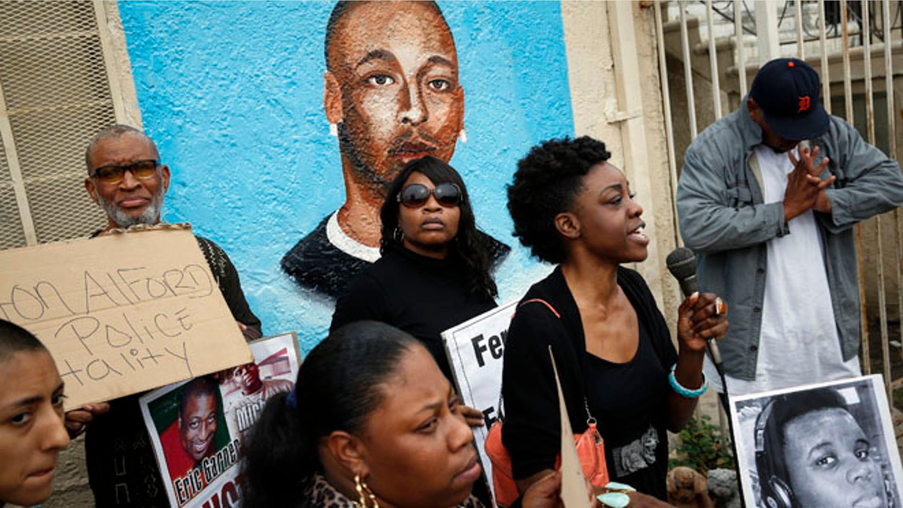 Dec. 1, 2014: Demonstrators rally against the Missouri grand jury's decision to not indict Darren Wilson for his fatal shooting of Michael Brown, in front of a mural of Ezell Ford, on the corner of Broadway and 65th Street in Los Angeles.