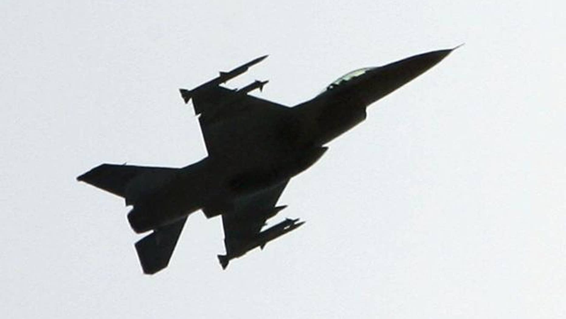 FILE: An F-16 fighter jet, fully armed with air-to-air missiles under its wings, maneuvers above the northwest section of Washington D.C.