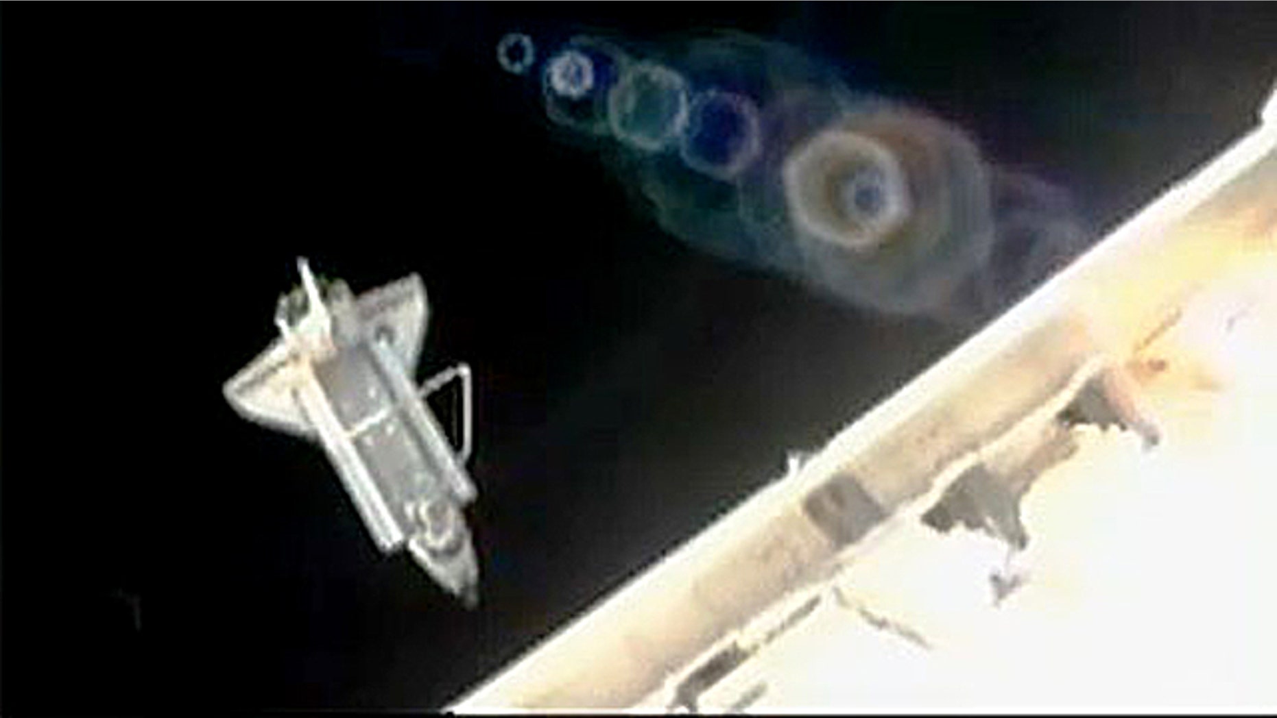 Space shuttle Discovery performs its flyaround shortly after undocking from the International Space Station.