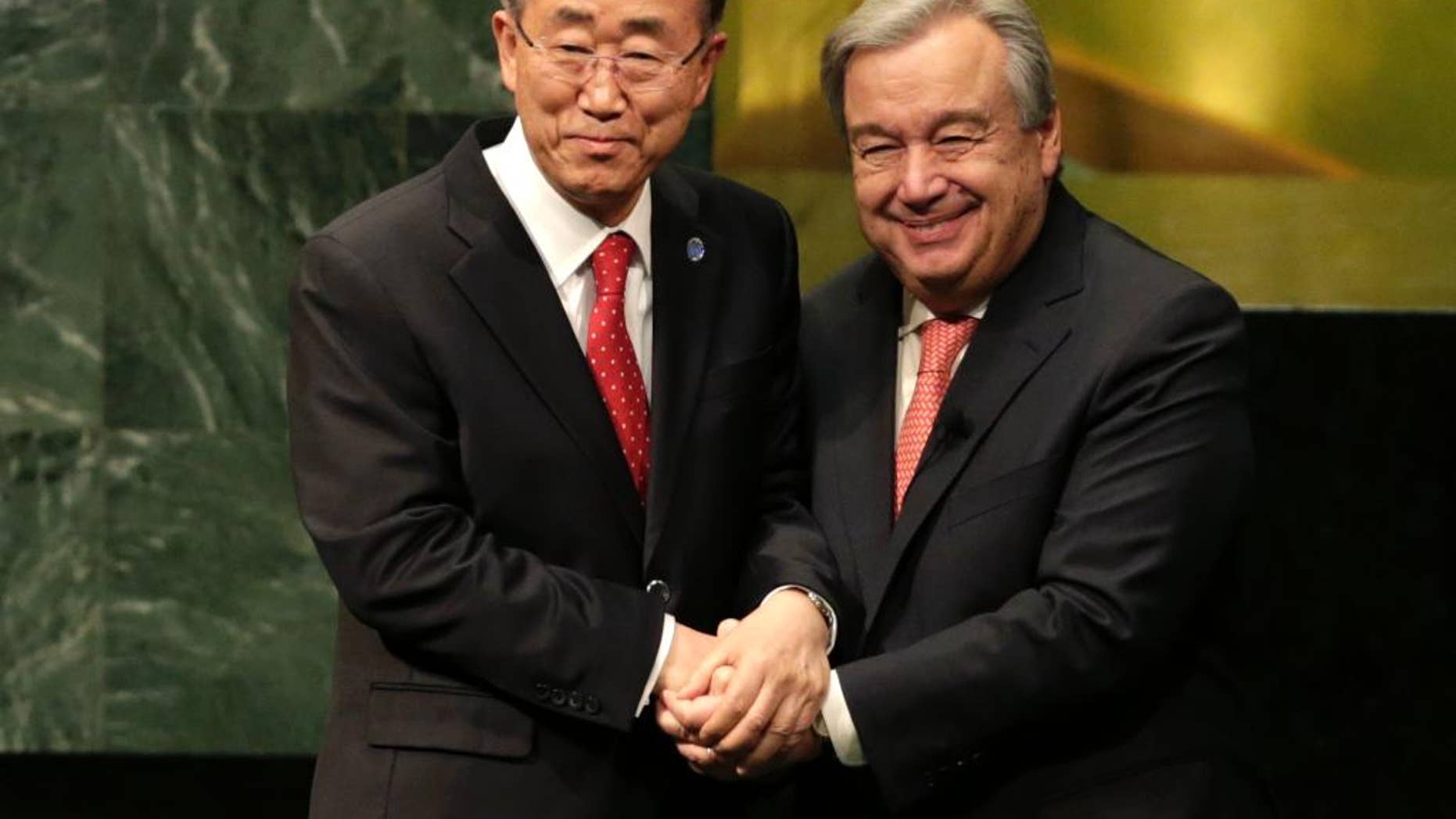 Current Secretary-General Ban Ki-moon, left, clasps hands with U.N. Secretary-General designate Antonio Guterres after Guterres was sworn in at U.N. headquarters, Monday, Dec. 12, 2016. (AP Photo/Seth Wenig)