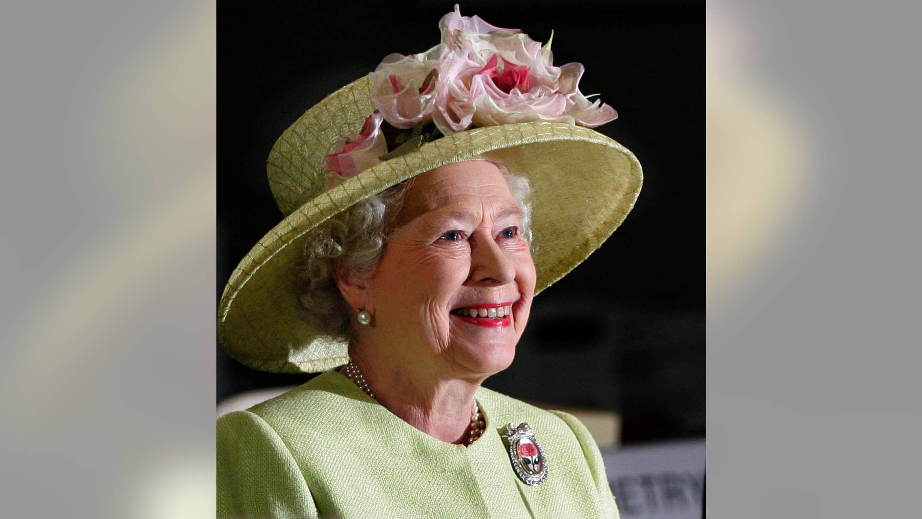FILE - In this May 8, 2007 file photo, Britain's Queen Elizabeth II smiles as she is greeted by astronauts aboard the International Space Station, via video conference, during her visit to NASA's Goddard Flight Center in Greenbelt, Md.. On Monday Feb. 6, 2017, Queen Elizabeth II marks her Sapphire Jubilee, becoming the first British monarch to reign for 65 years. (AP Photo/J. Scott Applewhite, File)