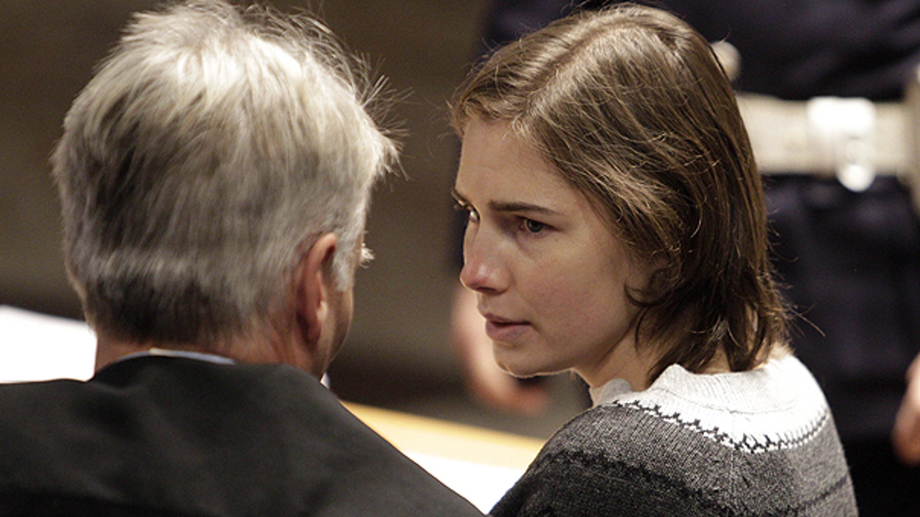 Dec. 11: Amanda Knox, right, talks to one of her lawyers during a hearing in her appeals trial, at Perugia's courthouse, Italy.