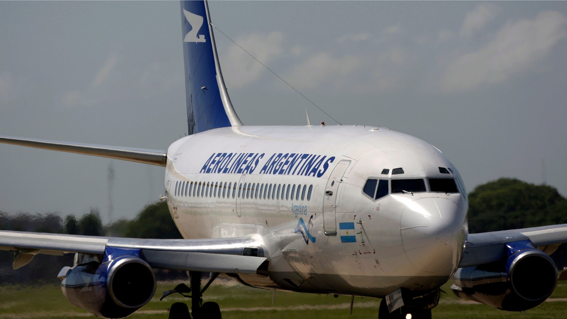 FILE - In this Dec, 17, 2008, file photo, an Aerolineas Argentinas jetliner prepares for takeoff from the Buenos Aires airport, in Argentina. Prosecutors in Argentina brought a local criminal complaint of fraud on Monday, Sept 14, 2015, against a U.S. litigation fund group and a Spanish company that managed the South American country's flagship airlines. (AP Photo/Natacha Pisarenko, File)