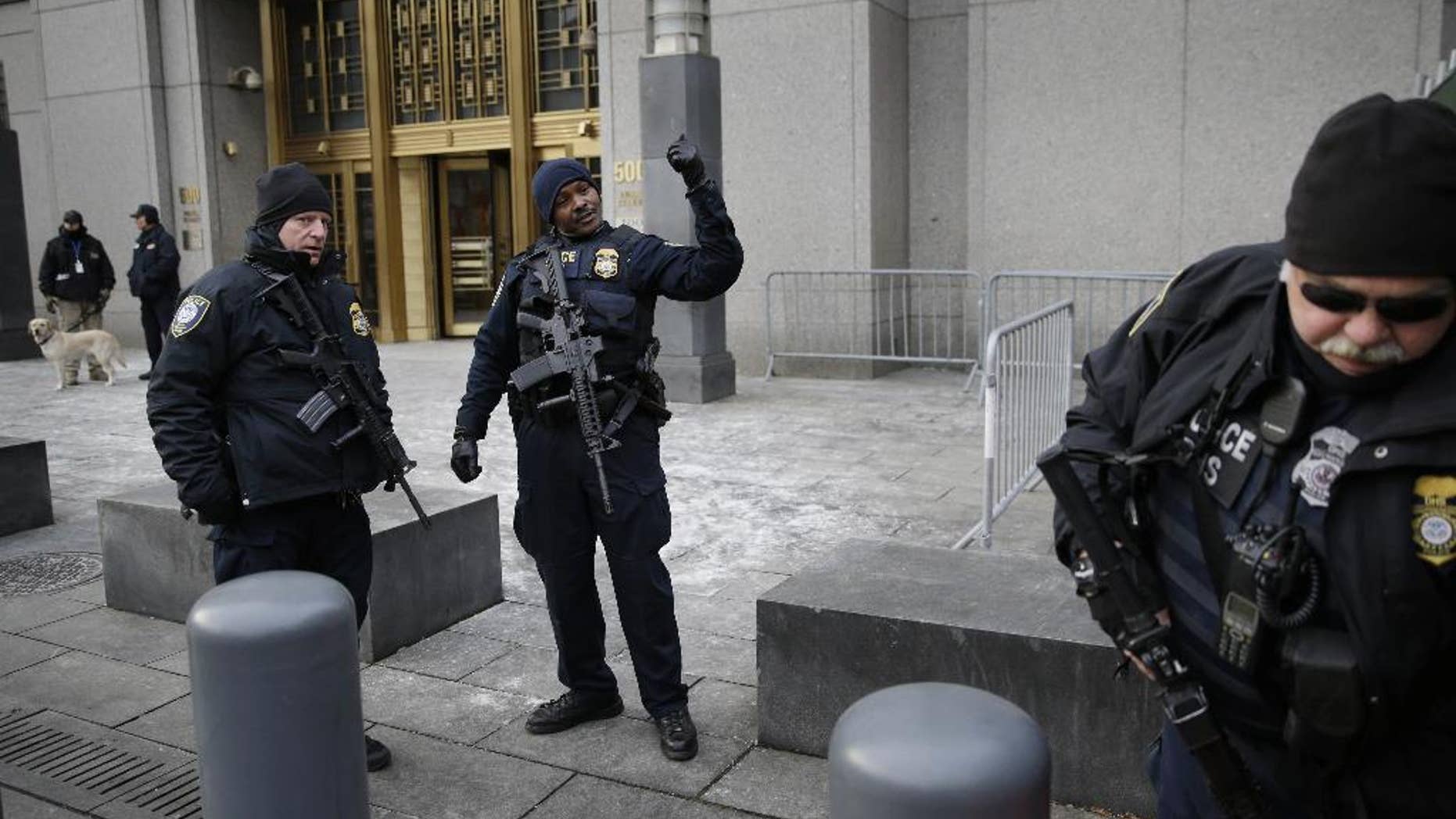 FILE - In this Jan. 22, 2015 file photo, security police watch over the entrance to a federal courthouse in New York where the trial of a man charged with conspiring in the 1998 bombings that killed 224 people at two U.S. embassies in Africa is taking place. Fears over the terror attacks in Paris have raised security at the city's federal courthouses to levels not seen since the days following the Sept. 11, 2001, attacks. (AP Photo/Seth Wenig, File)
