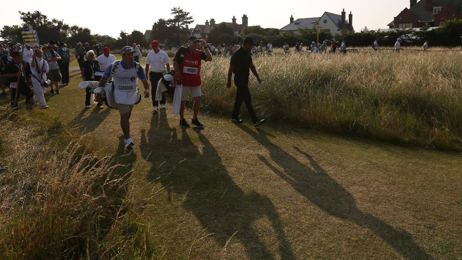 Tiger Woods of the US walks off the 18th hole after finishing his round on the second day of the British Open Golf championship at the Royal Liverpool golf club, Hoylake, England, Friday July 18, 2014. (AP Photo/Jon Super)