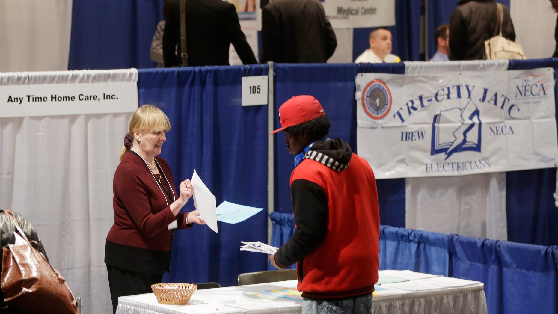 In this Thursday, April 11, 2013, photo, Kathie Maiello of Any-Time Home Care, left, talks with Jashod Chaney of Albany at the Dr. King Career Fair at the Empire State Plaza Convention Center, in Albany, N.Y. The Labor Department reports on the number of Americans who applied for unemployment benefits last week on Thursday, April 25, 2013. (AP Photo/Mike Groll)