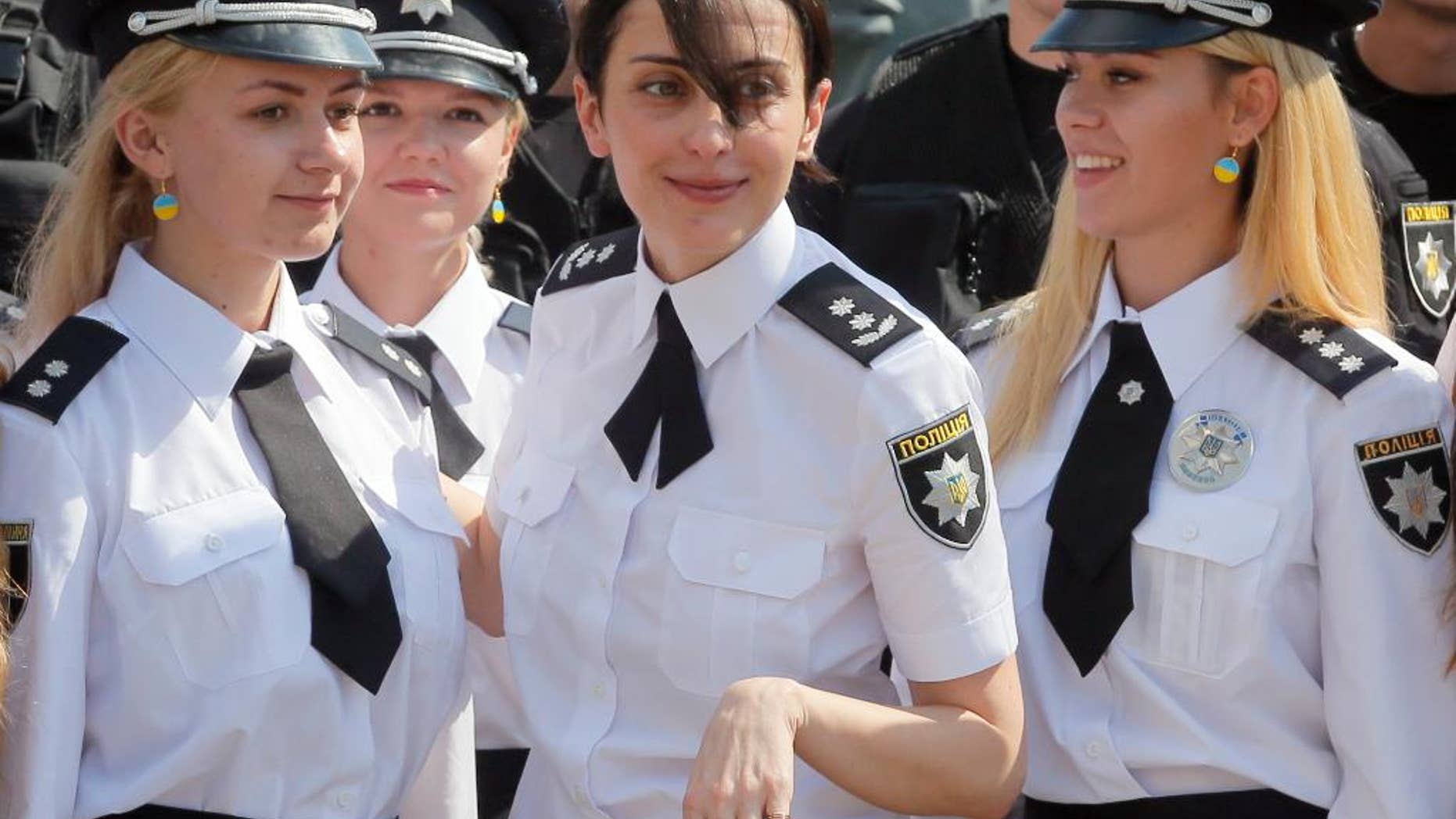 FILE In this Thursday, Aug. 4, 2016 file photo head of the National Police of Ukraine Khatiya Dekanoidze, centre, speaks with police officers during National Police Day in Kiev, Ukraine. Dekanoidze, who was driving reforms through the country's notoriously corrupt police force, has resigned Monday Nov. 14, 2016, after a year in the job, complaining of government pressure. (AP Photo/Efrem Lukatsky, File)