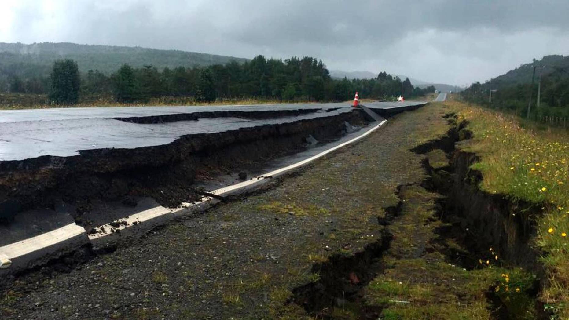 Cracks appear in and along a road near Quellon, Chile, Sunday, Dec. 25, 2016, after an earthquake. (Edinson Capdevilla/Aton via AP)
